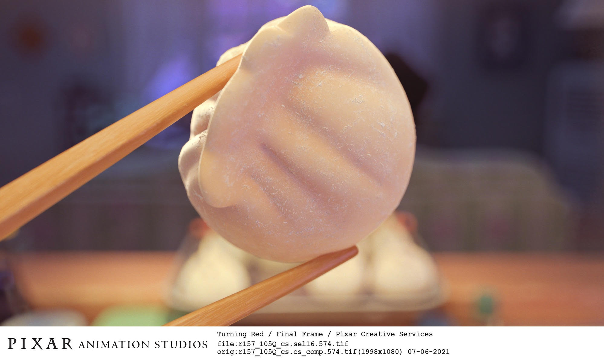 A shot from the film Turning Red of an uncooked bao held between chopsticks.