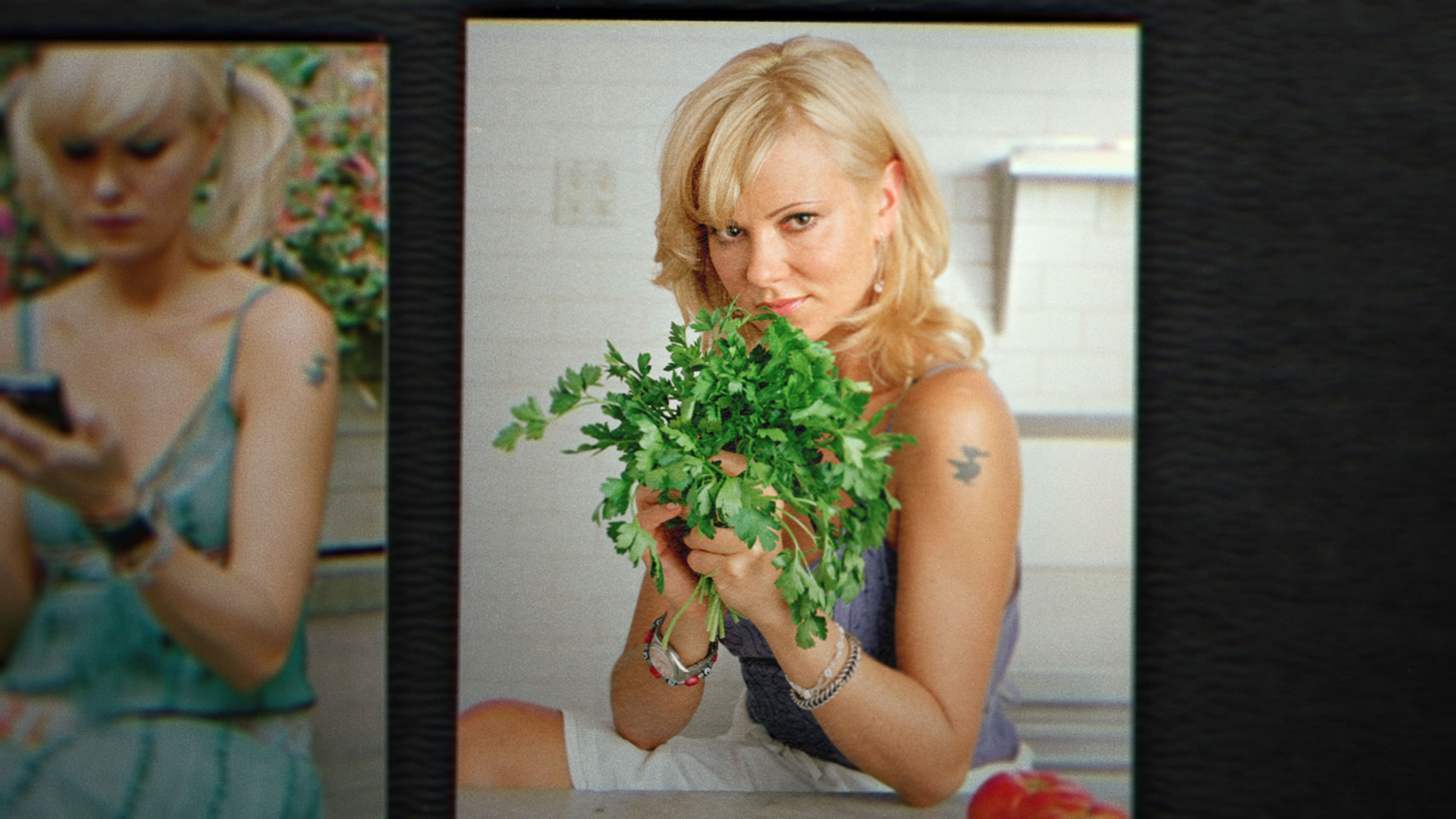 Still from “Bad Vegan” shows photo of woman holding up a bunch of cilantro and posing for the camera.