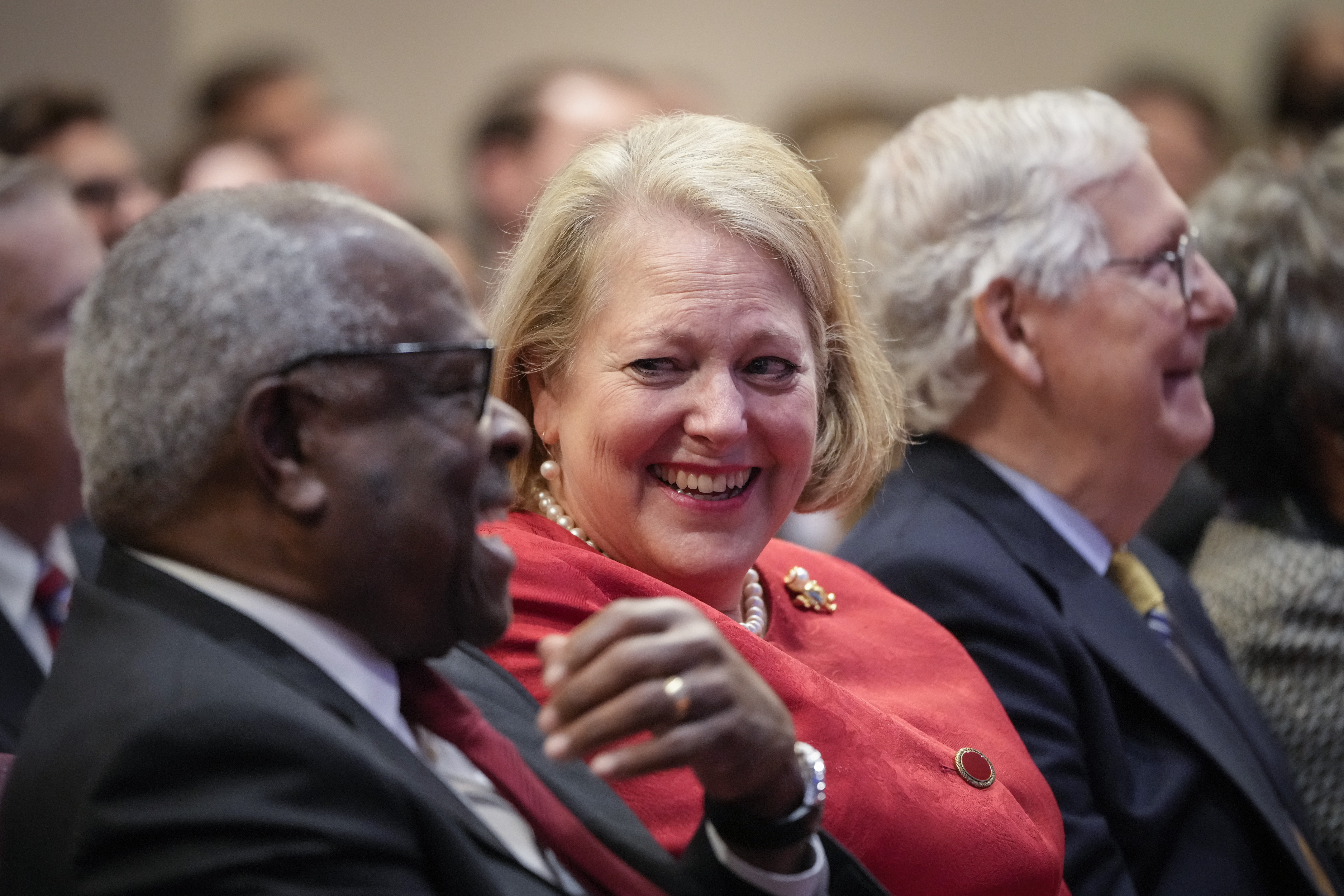 Justice Clarence Thomas, his wife Virginia Thomas, and Sen. Mitch McConnell sit in a row. 