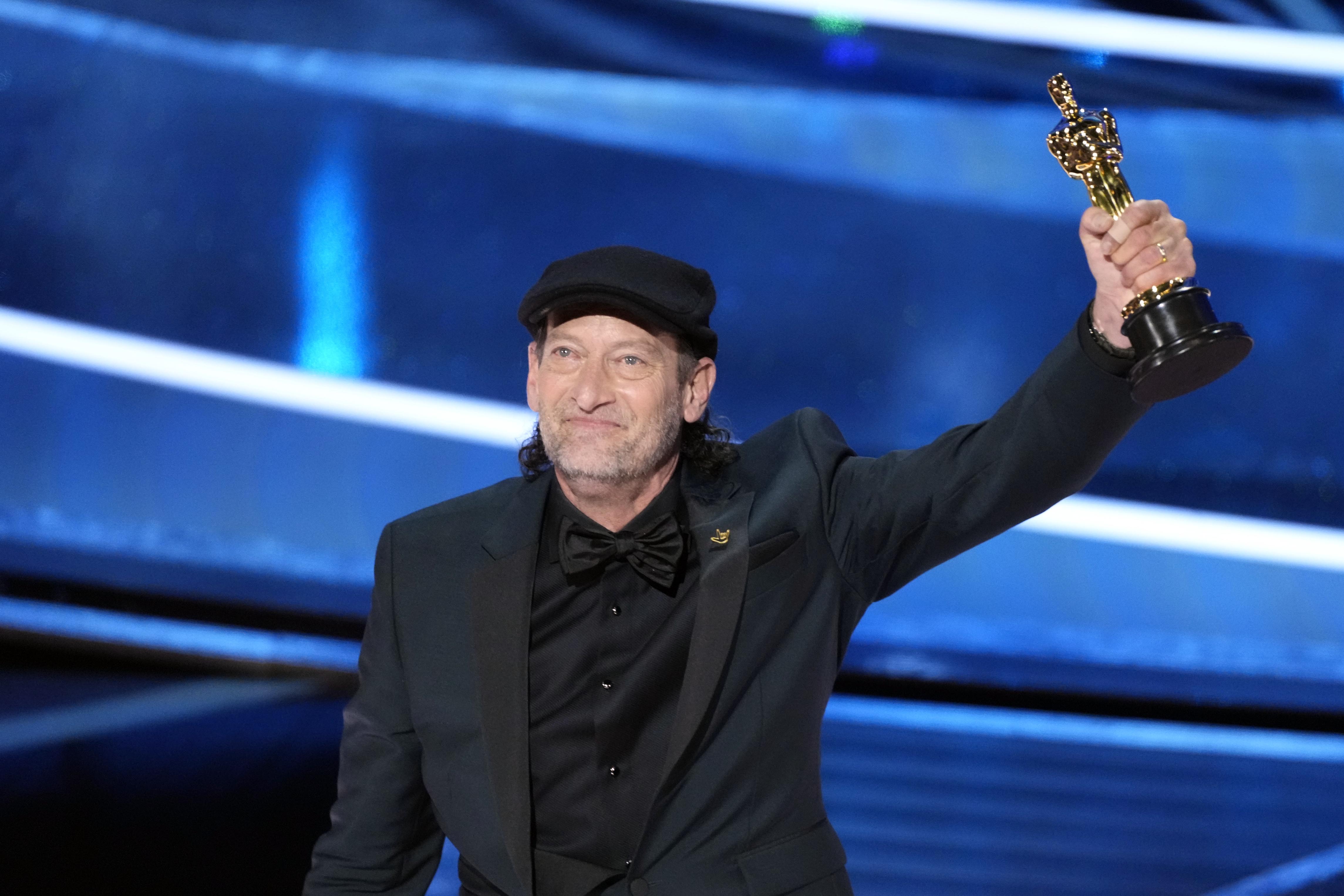 Troy Kotsur accepts the award for best actor in a supporting role for his performance in ”CODA” during the 94th Academy Awards at the Dolby Theatre.