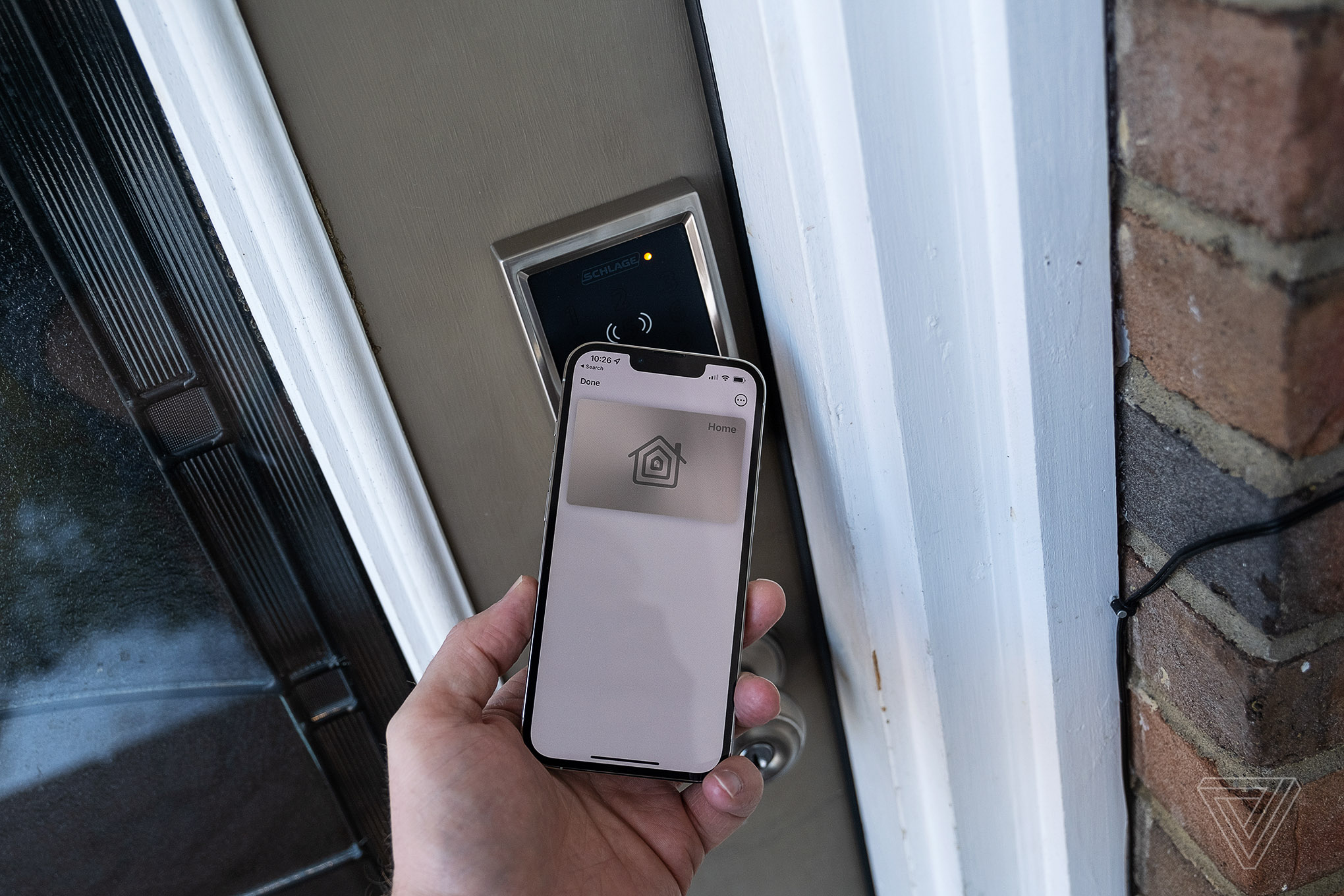 An iPhone being used to unlock the Schlage Encode Plus smart lock.