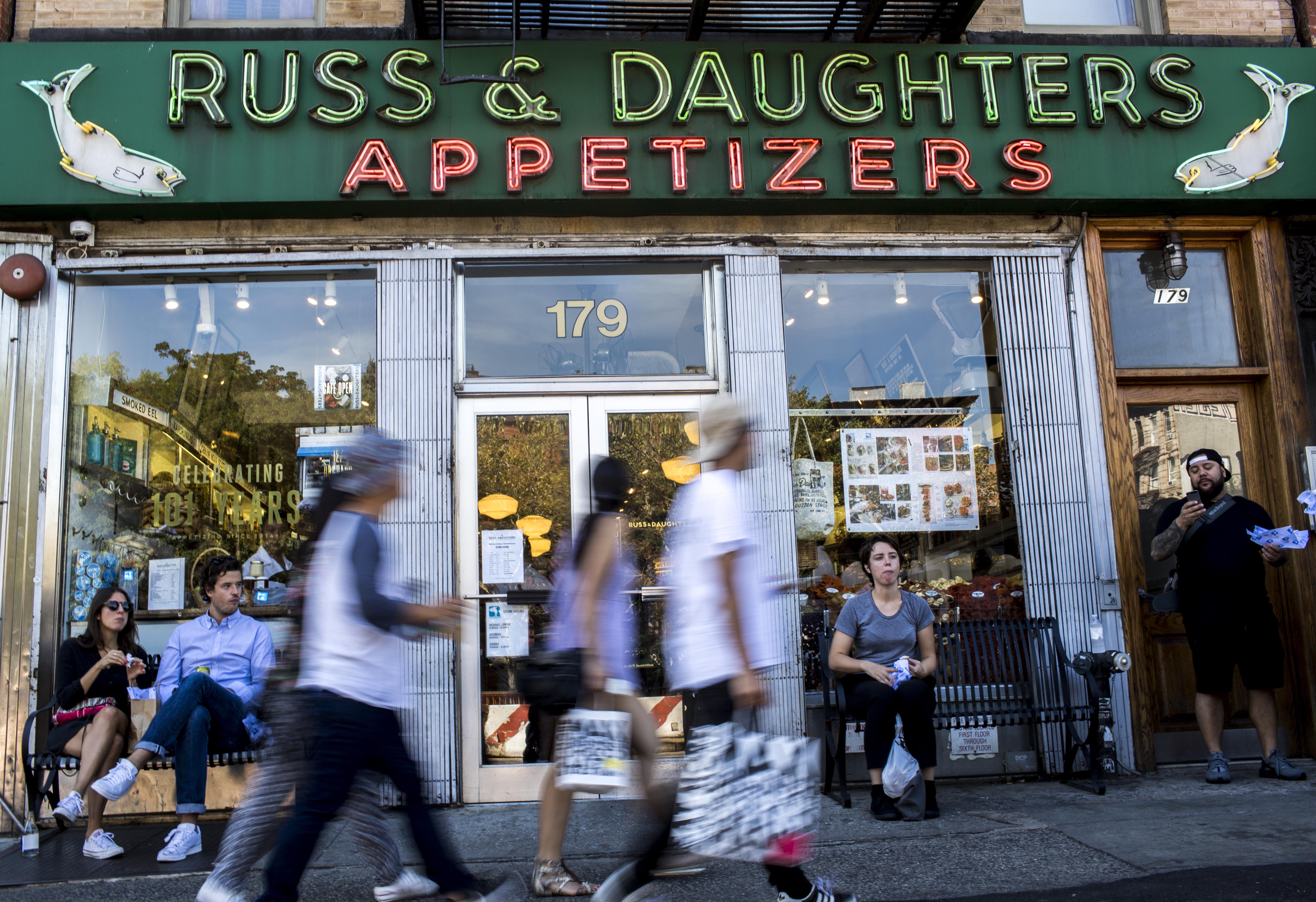 People eat food in front of Russ &amp; Daughters in New York City, on Wednesday, September 16, 2015.