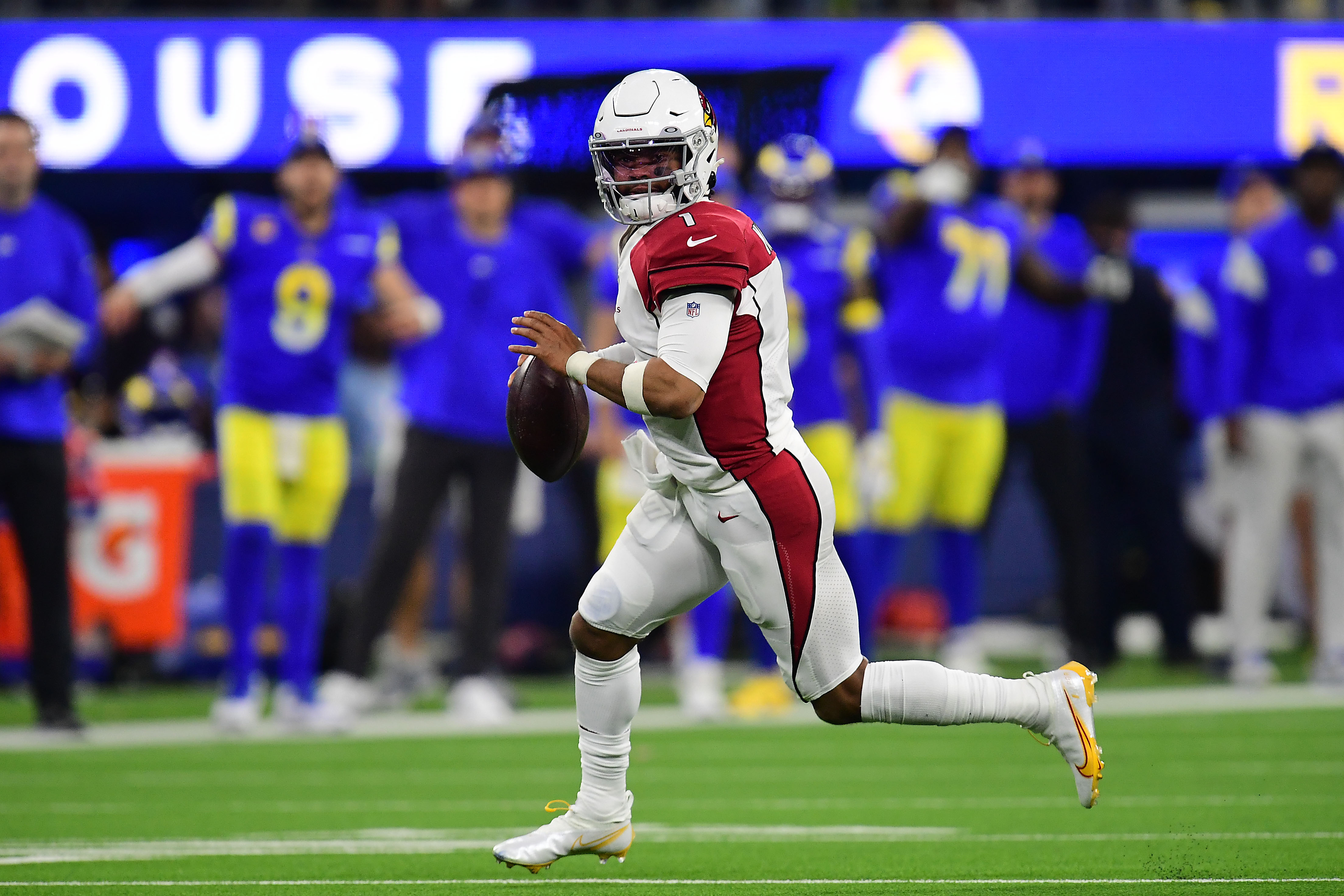 Arizona Cardinals quarterback Kyler Murray (1) runs out to pass against the Los Angeles Rams during the second half in the NFC Wild Card playoff football game at SoFi Stadium.