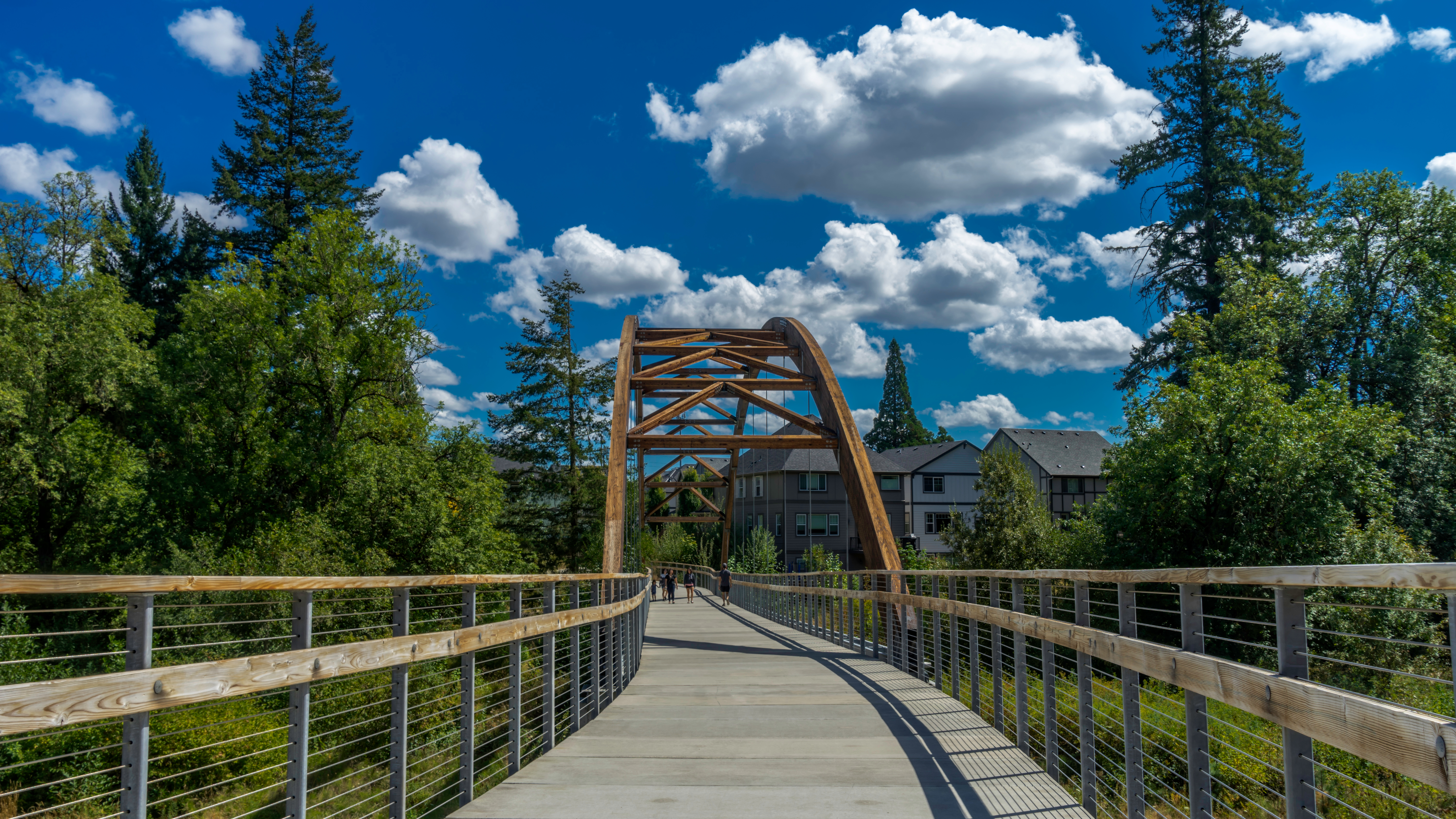 A walking bridge flanked by trees in Hillsboro, Oregon.