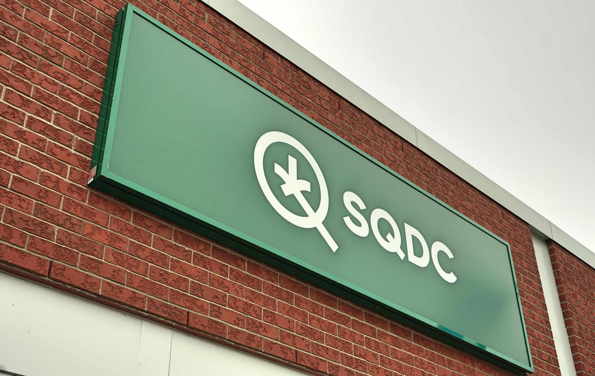 green sign that says “SQDC”