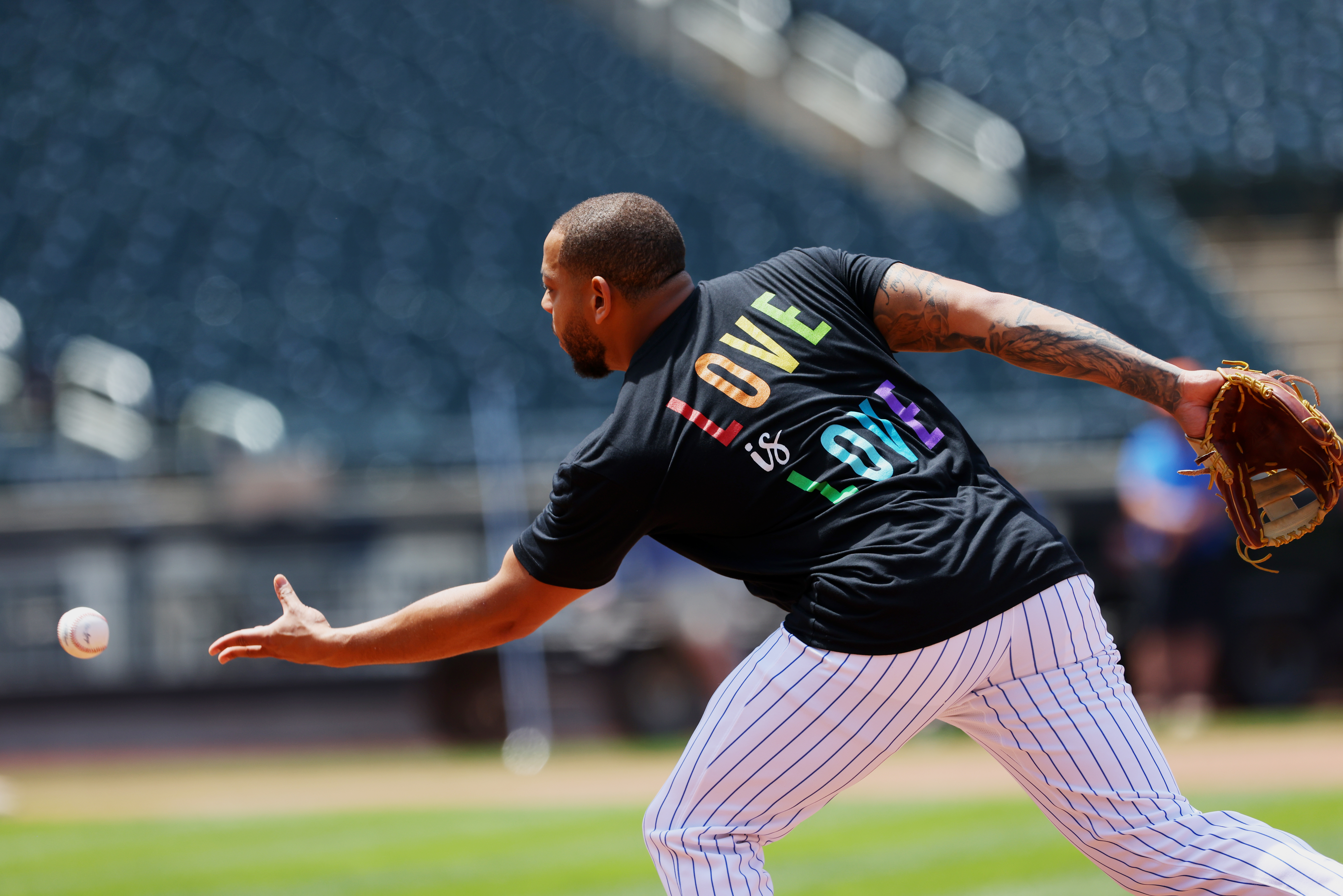 Dominic Smith of the New York Mets warms up with a “Love is Love” shirt in honor of Pride Night before a game against the Philadelphia Phillies at Citi Field on June 25, 2021.