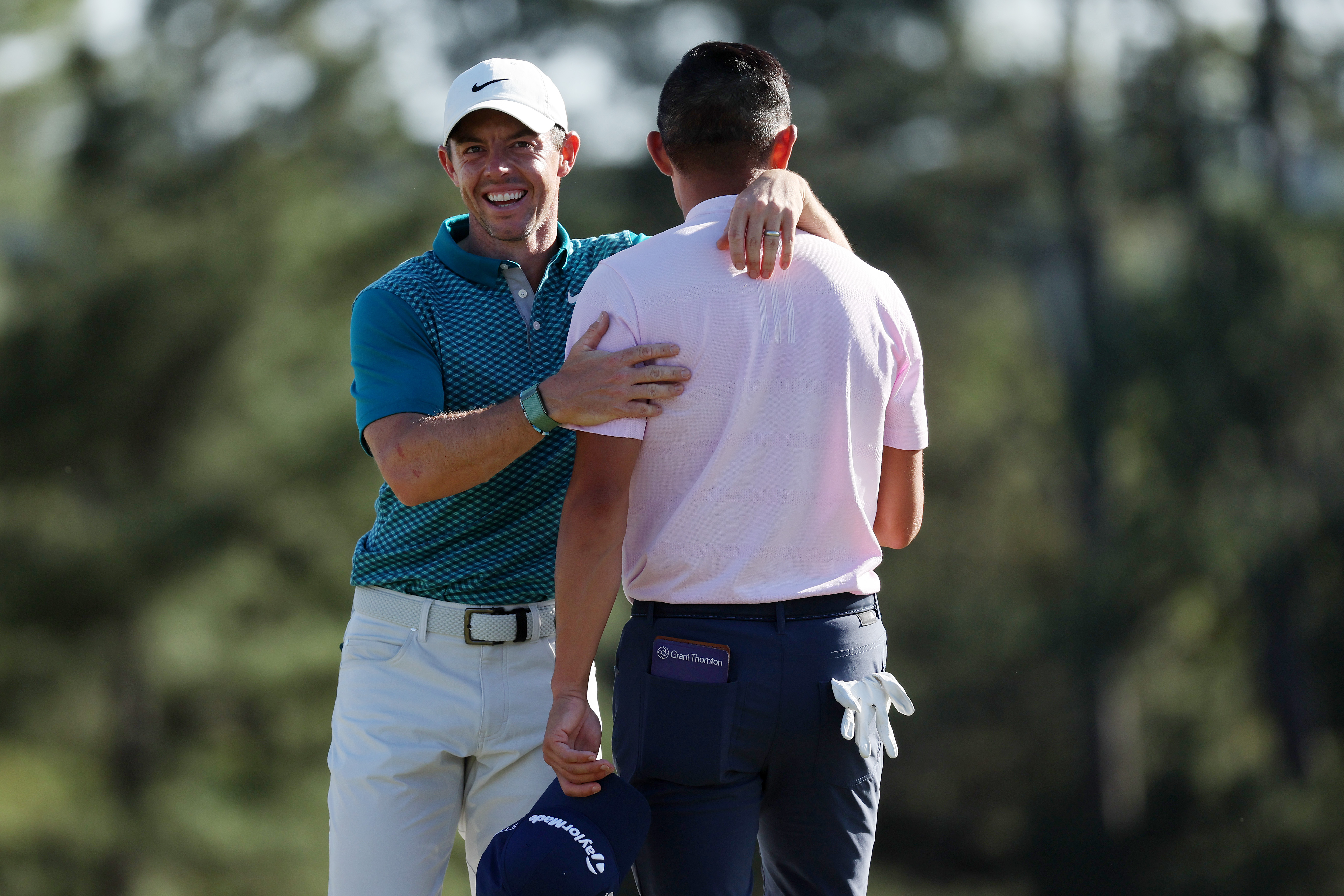 Rory McIlroy of Northern Ireland (L) and Collin Morikawa celebrate on the 18th green after finishing their round during the final round of the Masters at Augusta National Golf Club on April 10, 2022 in Augusta, Georgia.