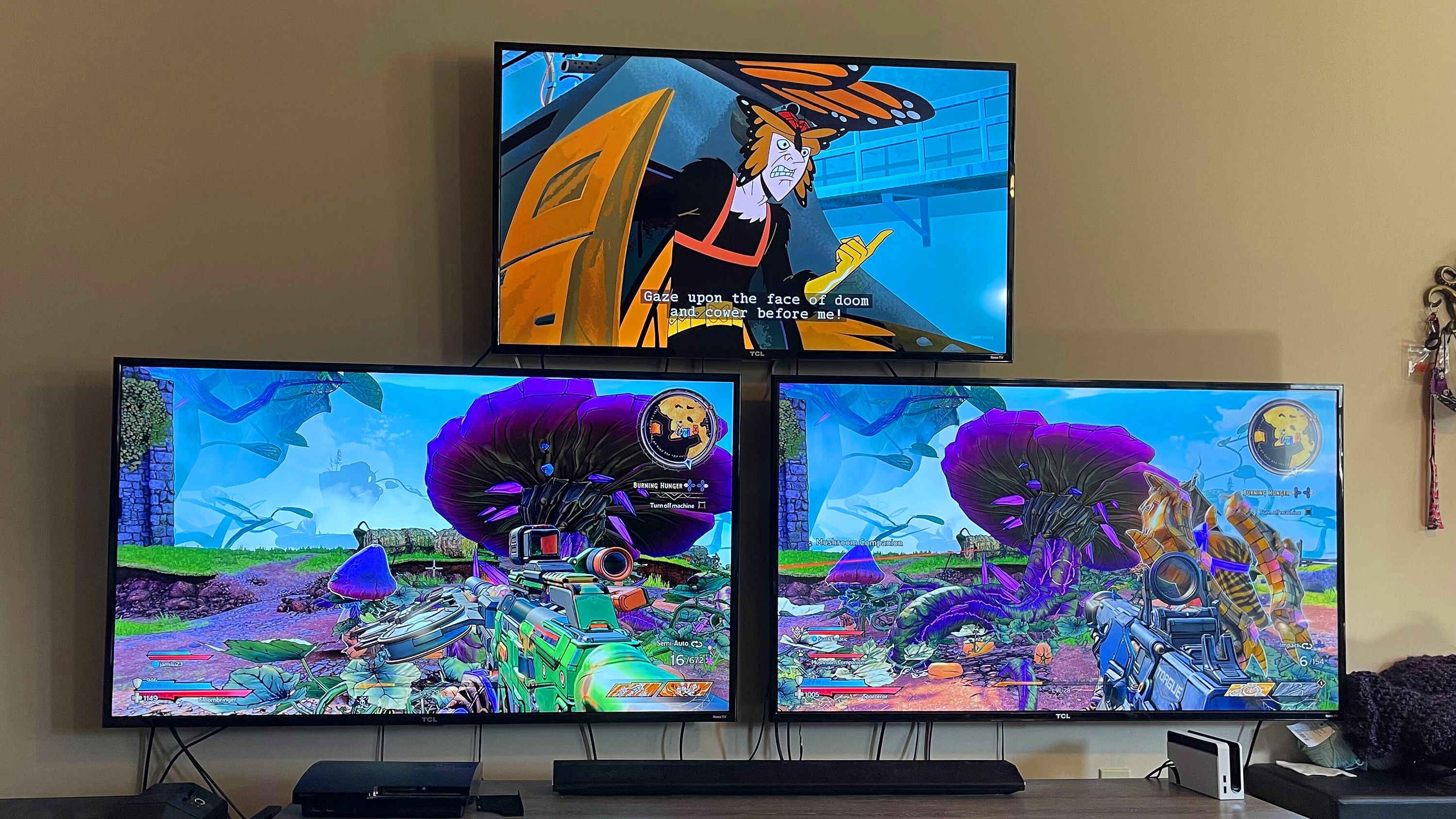 Two TVs show players playing Tiny Tina’s Wonderlands while Venture Bros. plays on the top TV