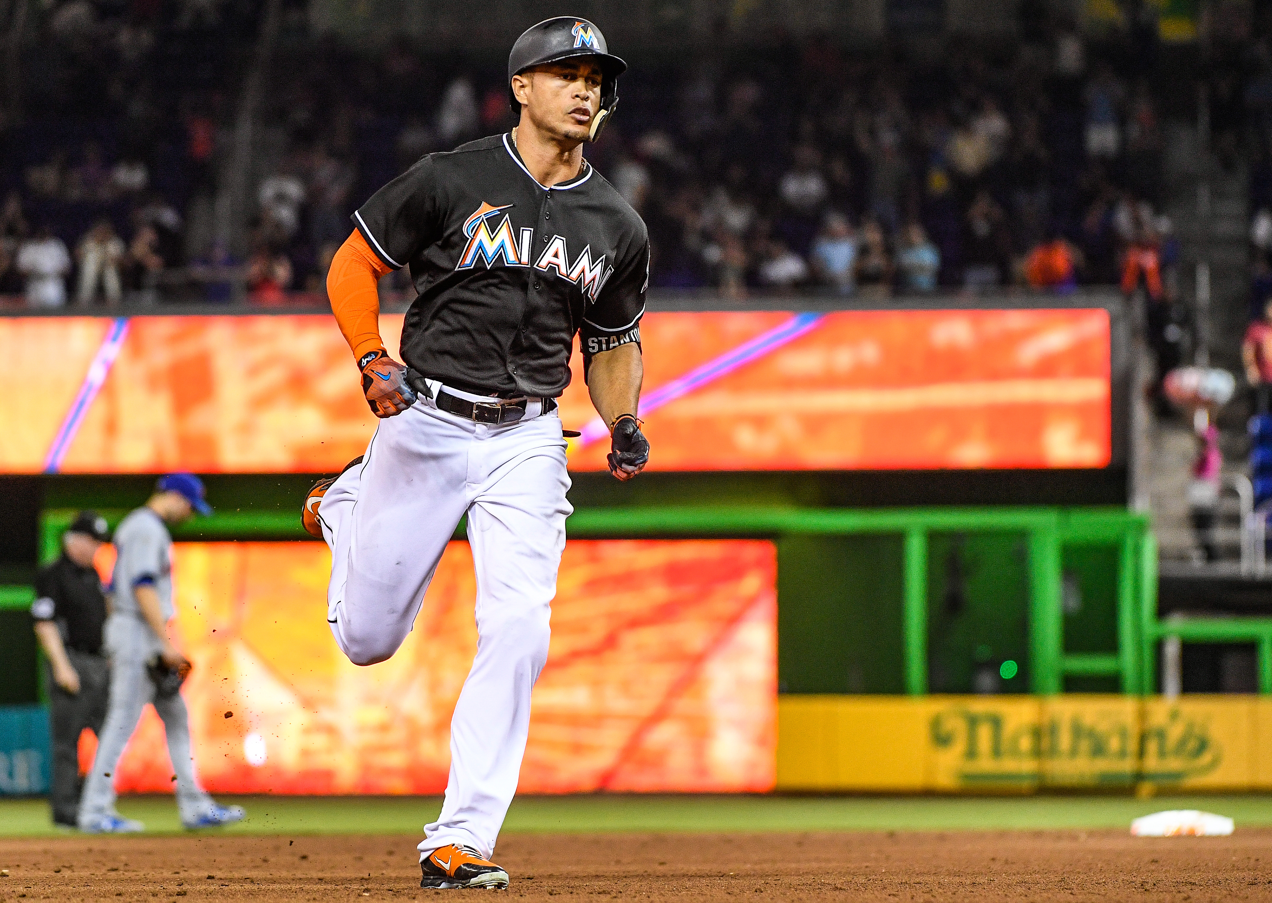 Giancarlo Stanton #27 of the Miami Marlins hits the go ahead home run in the eighth inning during the game between the Miami Marlins and the New York Mets at Marlins Park on April 15, 2017 in Miami, Florida.