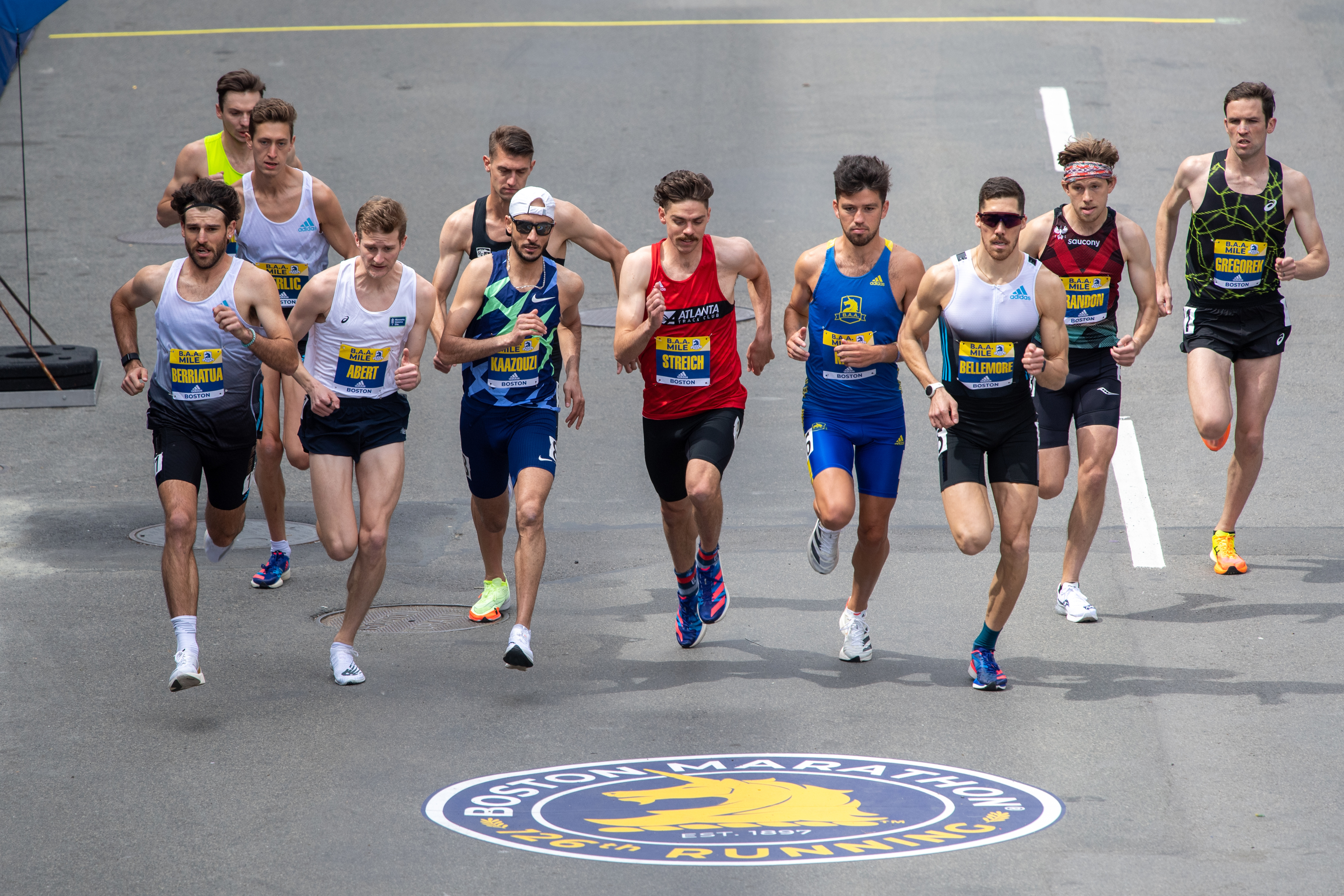 Runners in the men’s professional race run shortly after crossing the starting line of the BAA Invitational Mile on April 16, 2022 on Boylston Street in Boston, MA.