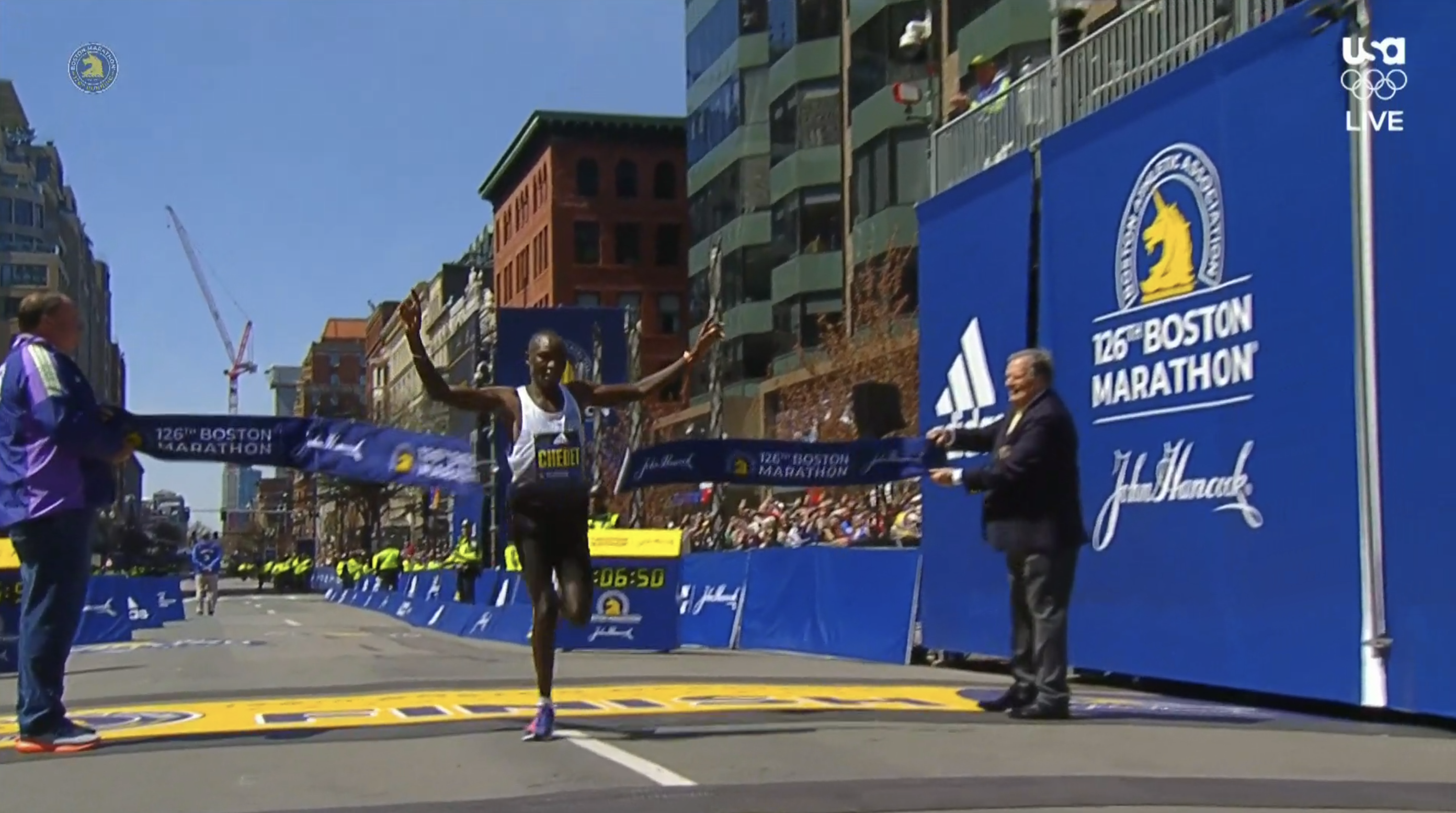 Kenyan male Evans Chebet crosses the finish line to win the 2022 Boston Marathon.