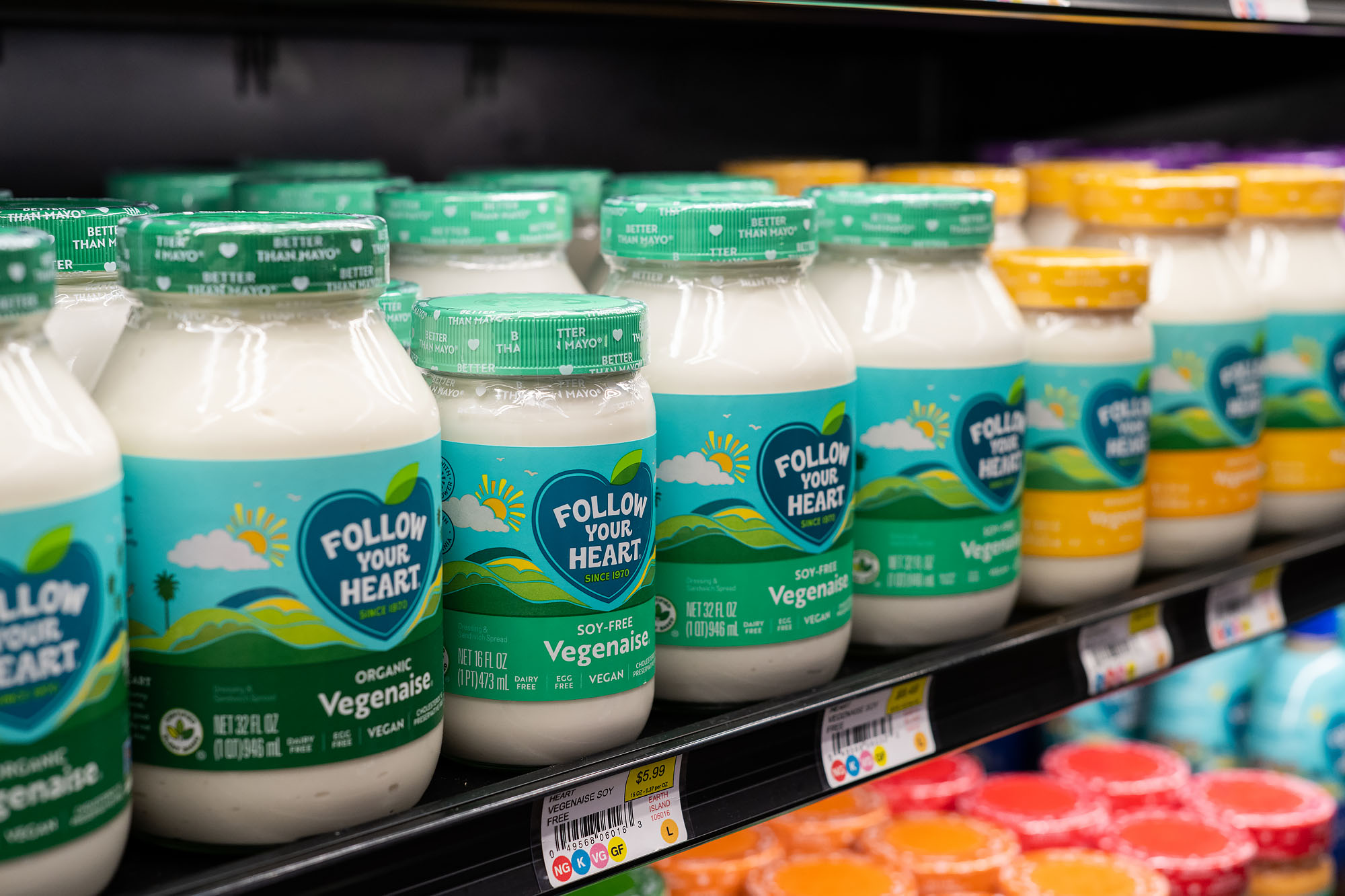 Rows of Vegenaise in a refrigerated display case.
