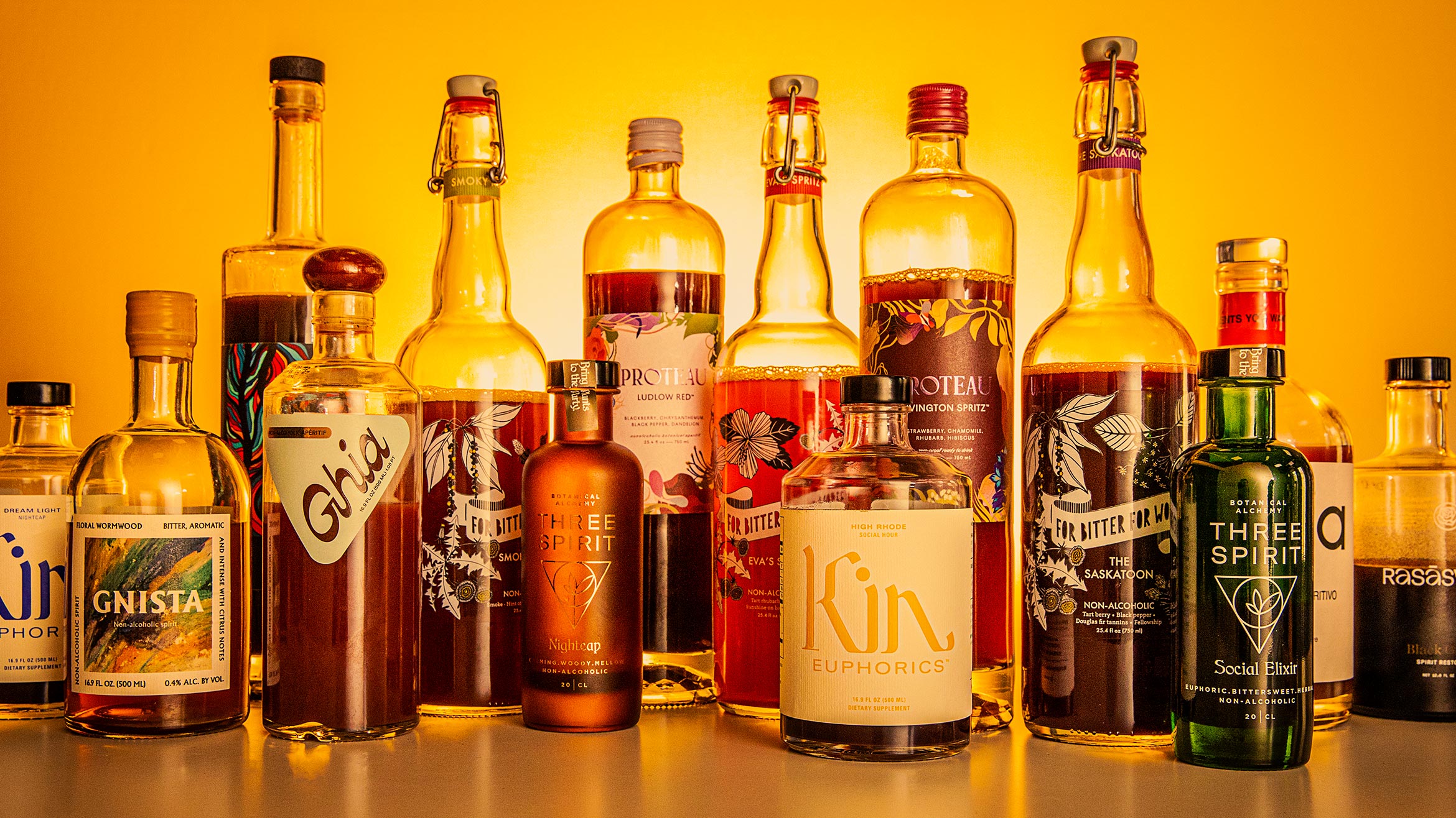Lineup of various nonalcoholic aperitif bottles.