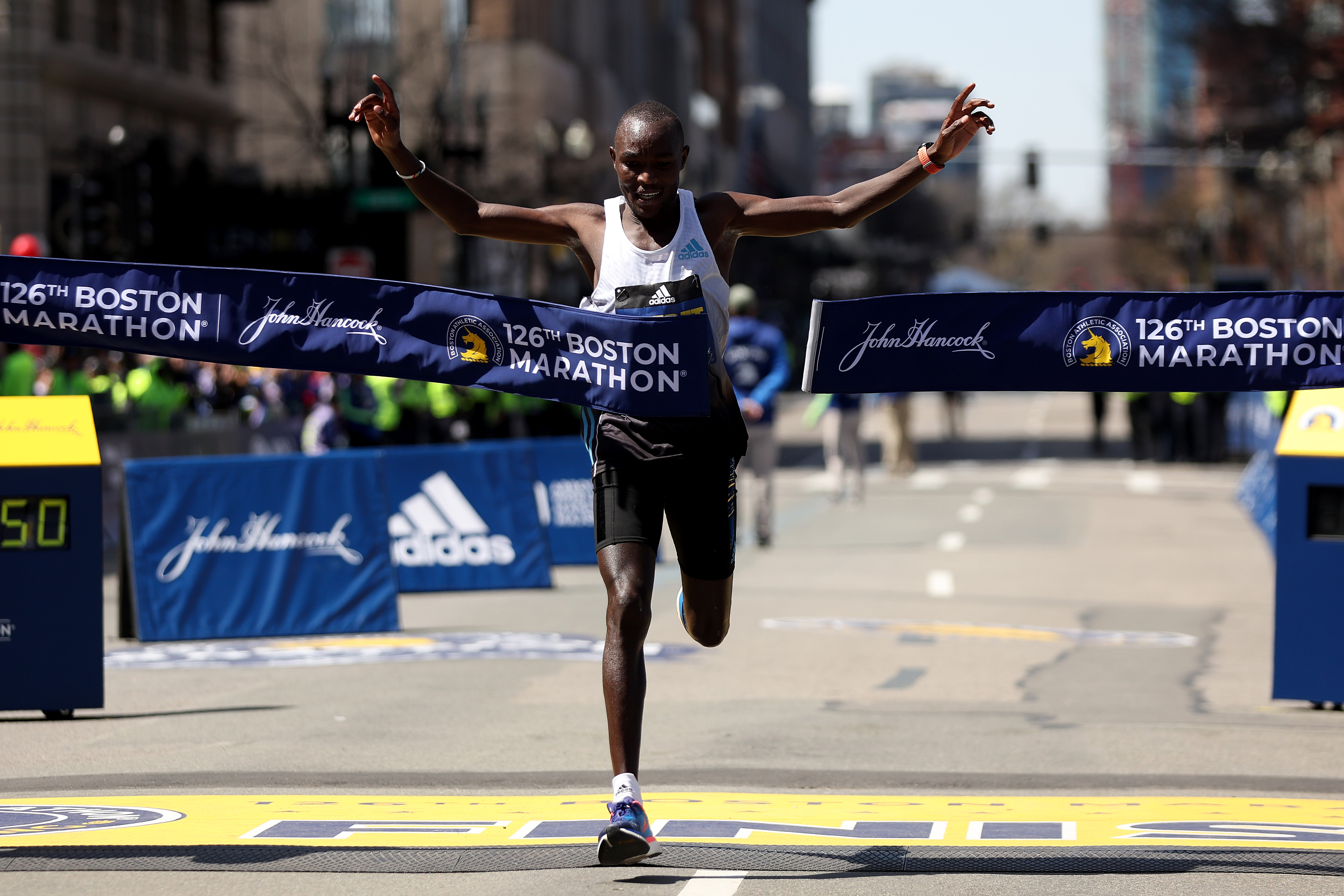 Evans Chebet of Kenya crosses the finish line to take first place in the professional men’s division during the 126th Boston Marathon on April 18, 2022 in Boston, Massachusetts.