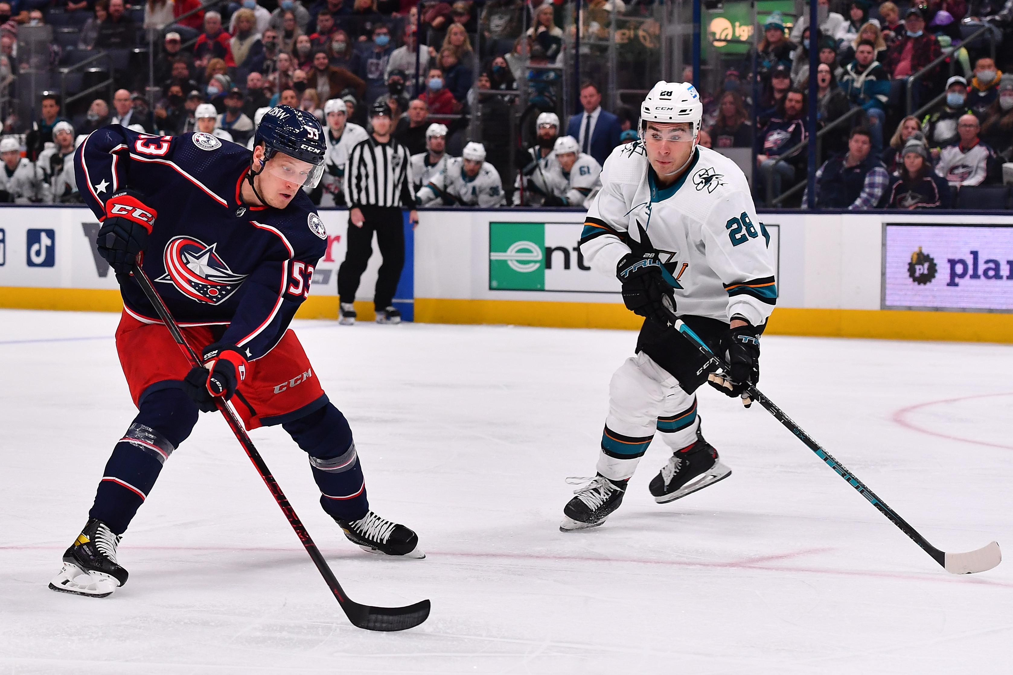 Gabriel Carlsson #53 of the Columbus Blue Jackets skates with the puck as Timo Meier #28 of the San Jose Sharks defends during the third period of a game at Nationwide Arena on December 5, 2021 in Columbus, Ohio.