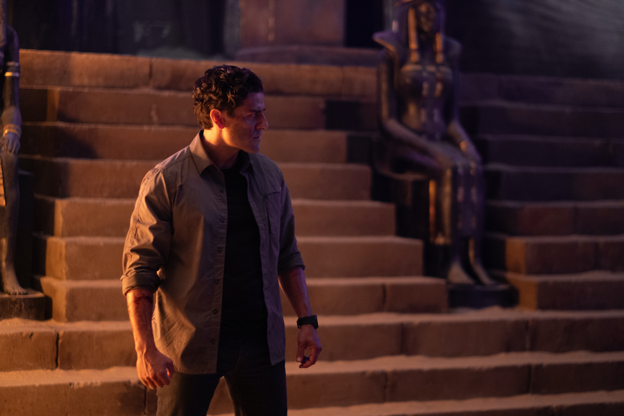 Oscar Isaac as Marc Spector/Steven Grant stands in the middle of a tomb in the Disney Plus series Moon Knight.