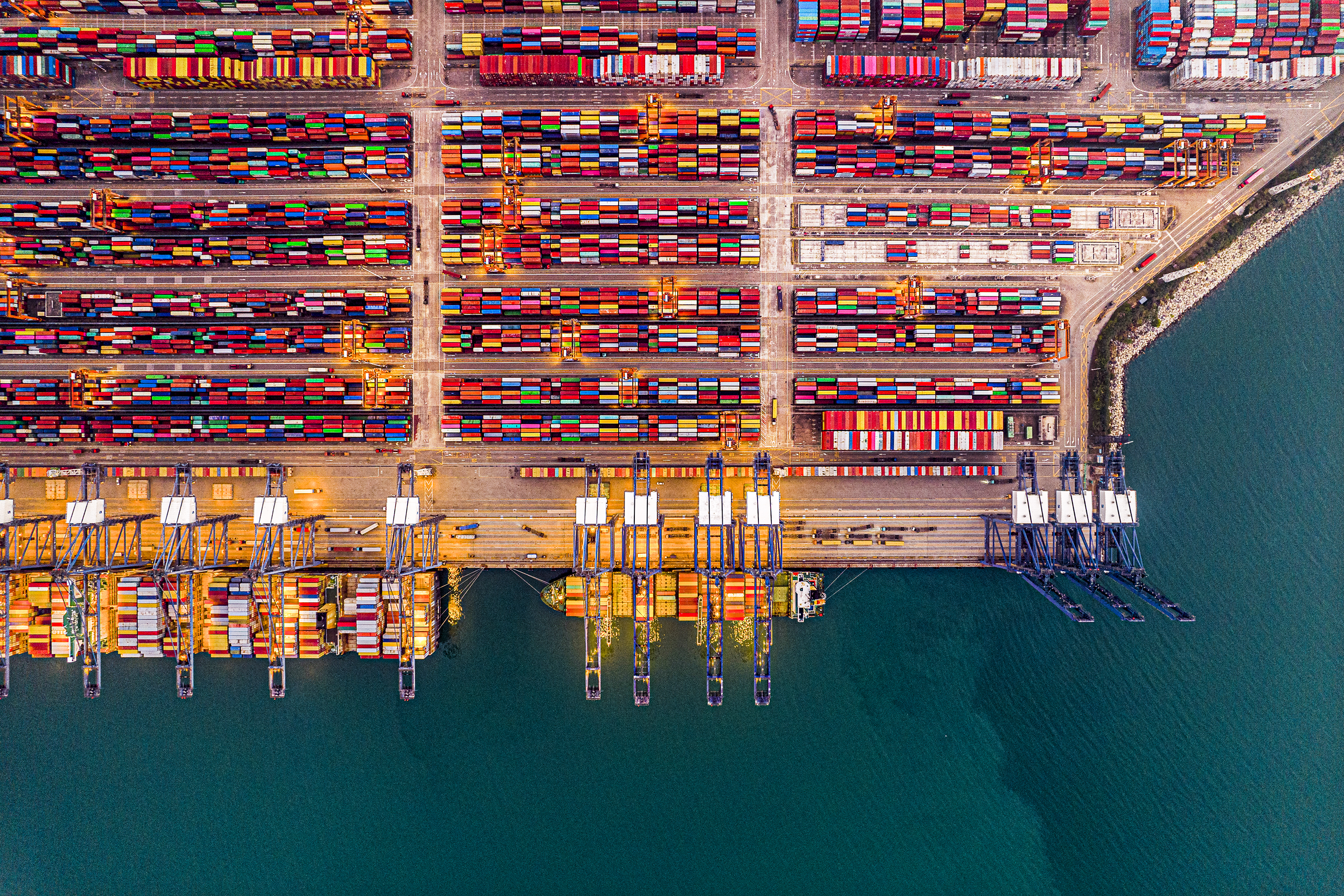 Aerial view of a port showing hundreds of shipping containers.