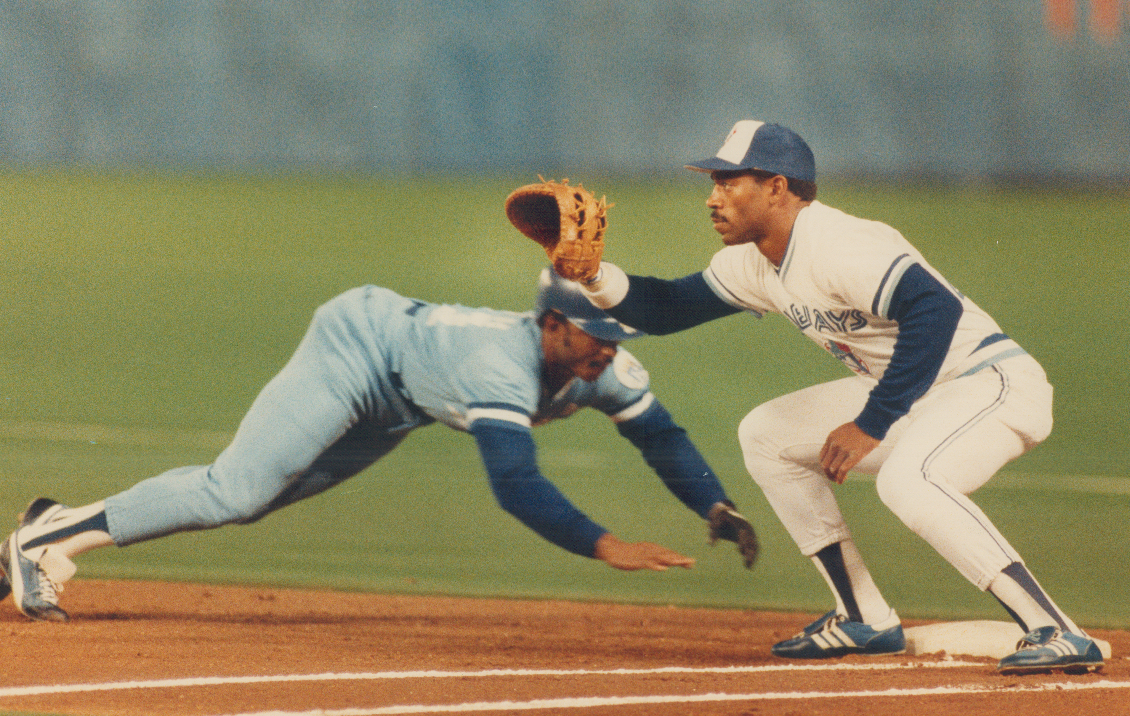 Close enough: Kansas City leftfielder Lonnie Smith does a racing dive to get back to first base on a
