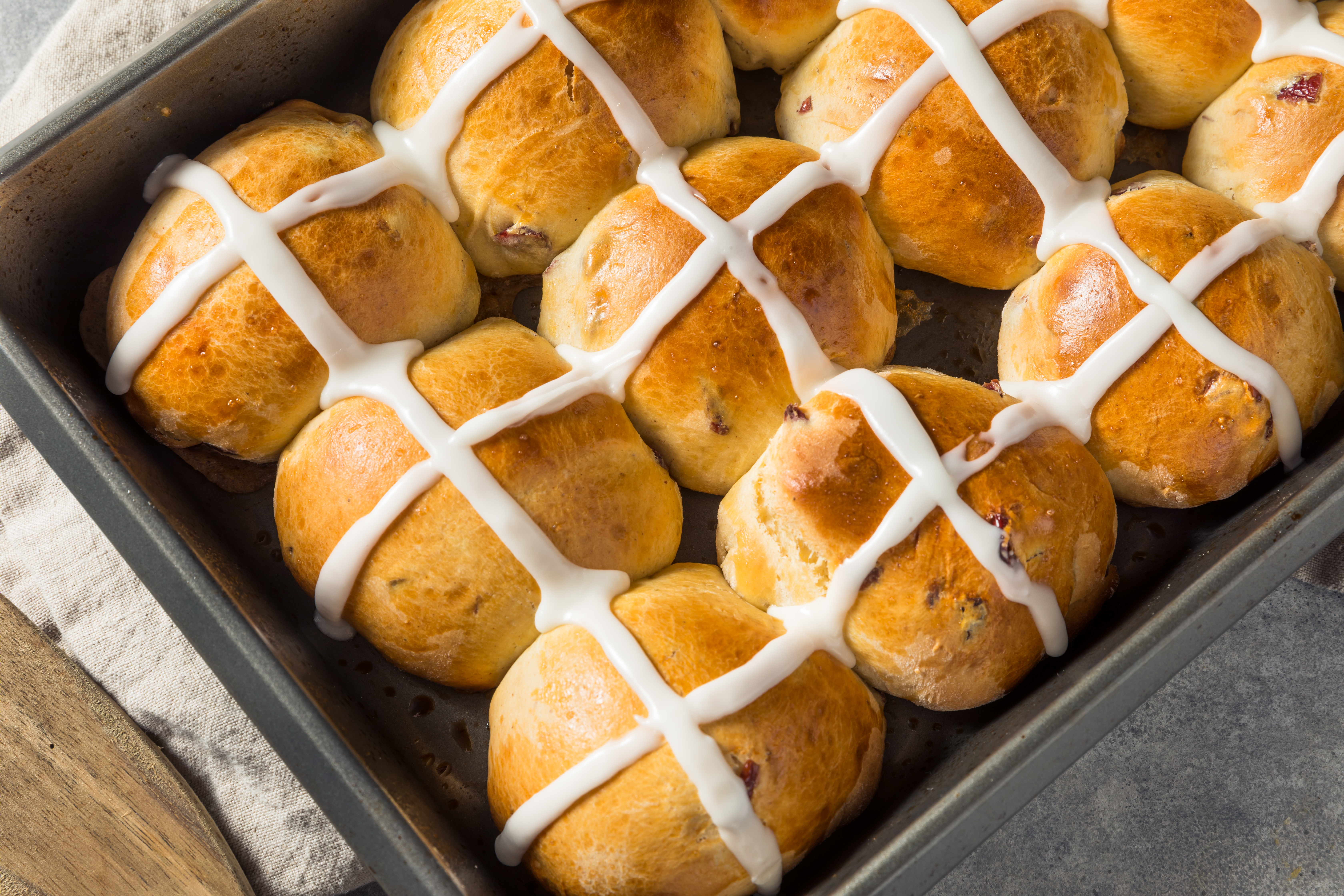 Pan of hot cross buns on the counter.