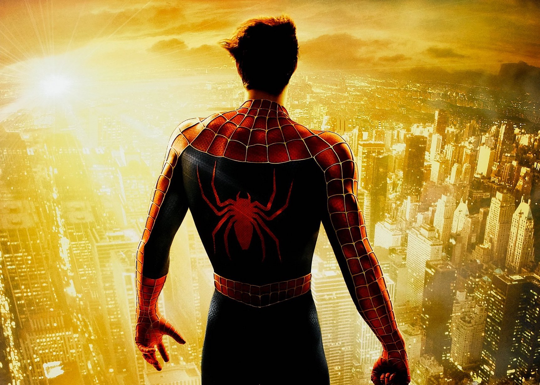 Detail from the Spider-Man 2 poster, with Peter Parker in Spider-Man costume, his mask off, back to the camera, facing out over a sunlit New York City