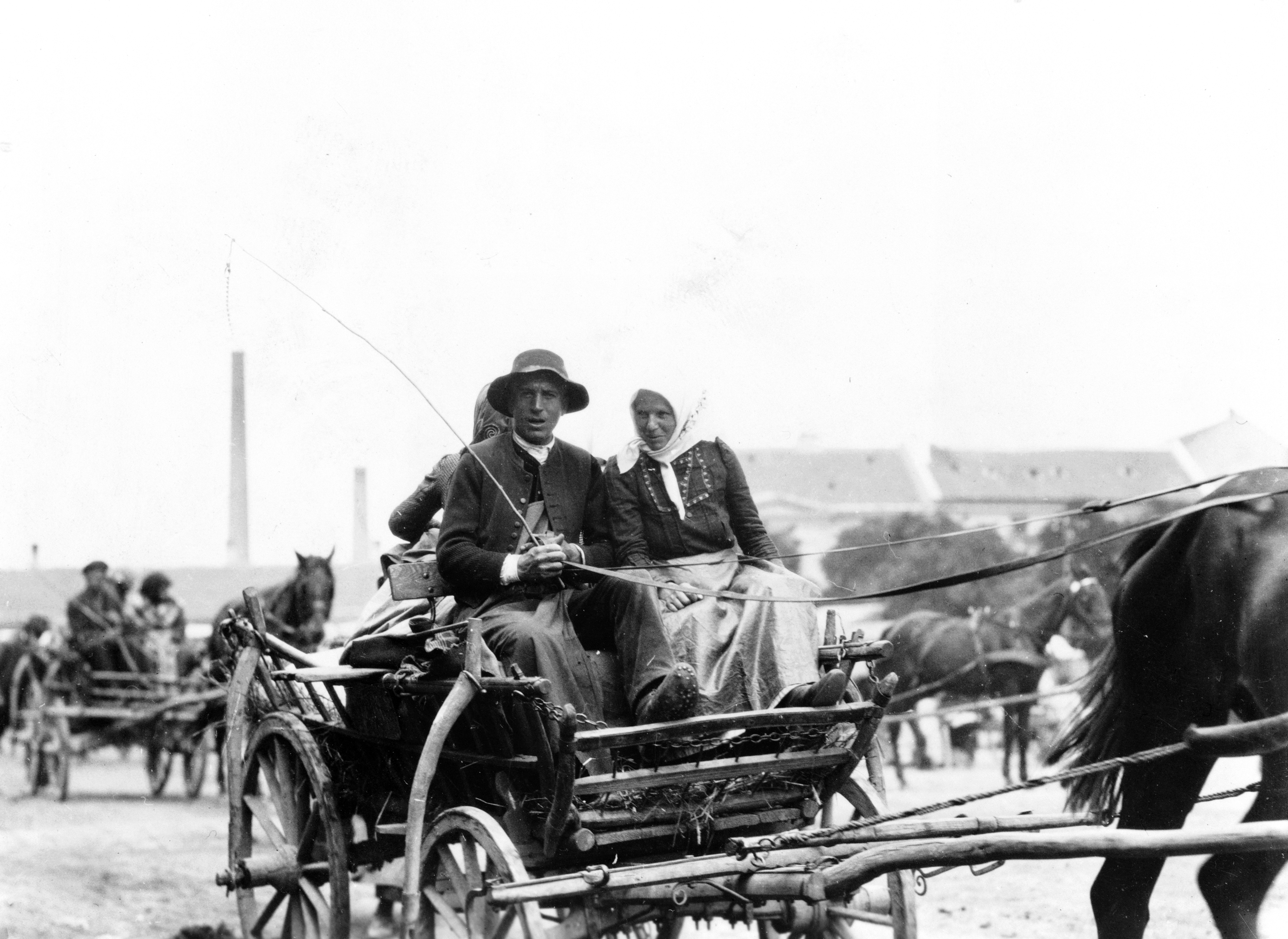 Man and woman on horse-drawn wagon, returning from market, Hungary 1923