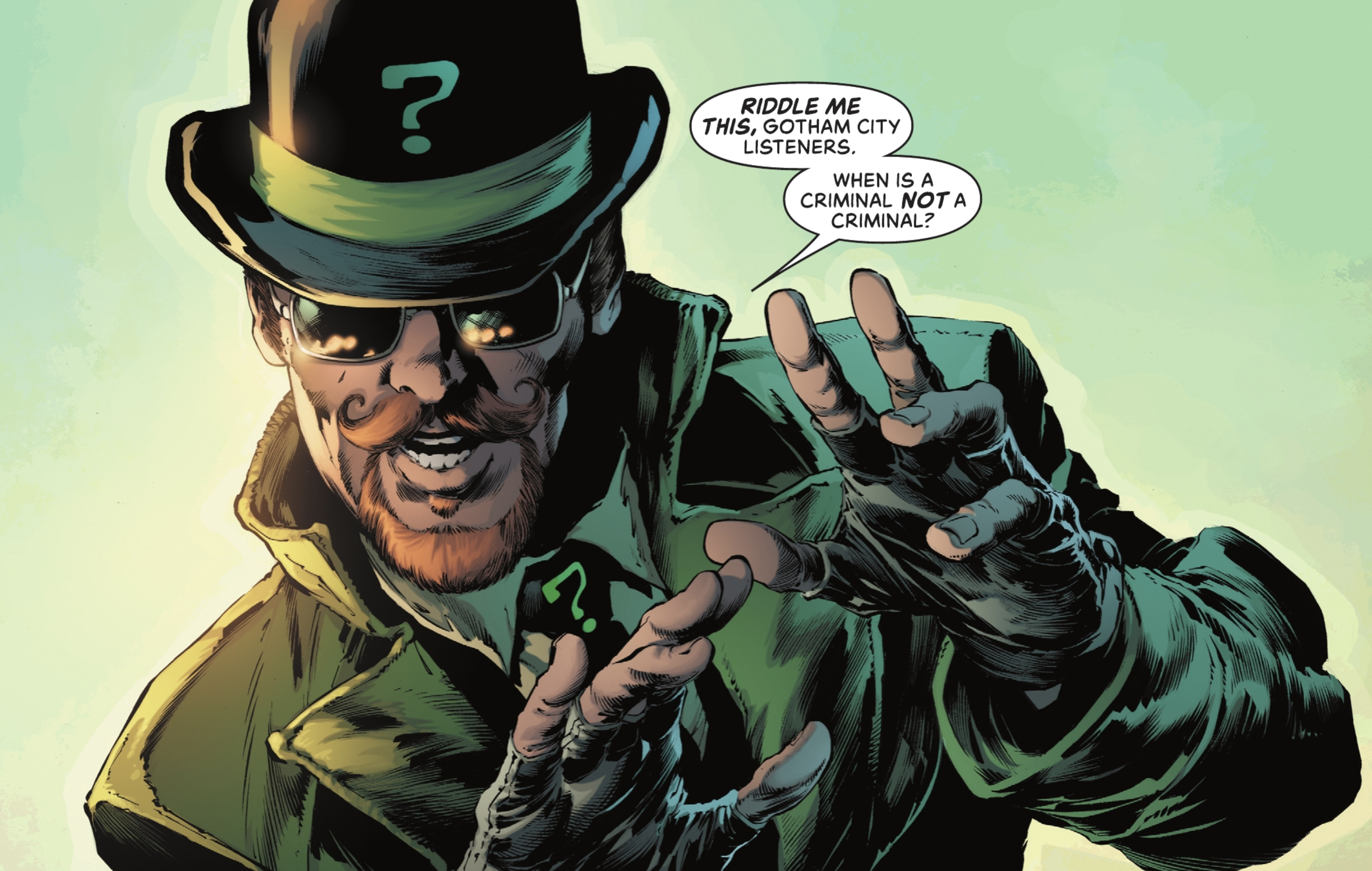“Riddle me this, Gotham City listeners. When is a criminal not a criminal?” says the Riddler, wearing a bowler hat, sunglasses, a goatee and curled waxed mustache, and holding his hands up illustratively in front of him. He’s wearing a green suit and fingerless gloves and looks like a total asshole in Detective Comics #1059 (2022). 