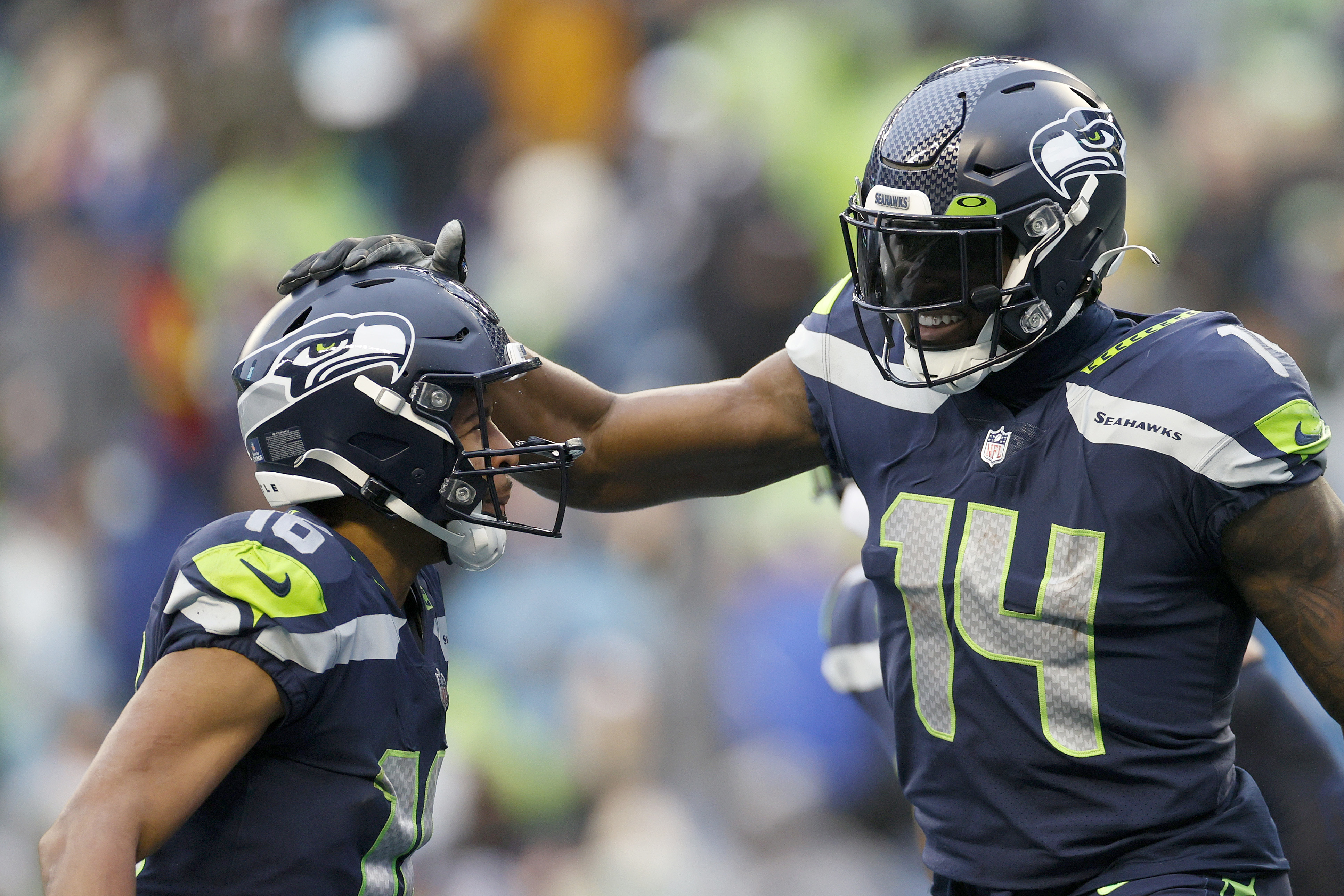 Tyler Lockett #16 and DK Metcalf #14 of the Seattle Seahawks celebrate a touchdown during the third quarter against the Detroit Lions at Lumen Field on January 02, 2022 in Seattle, Washington.