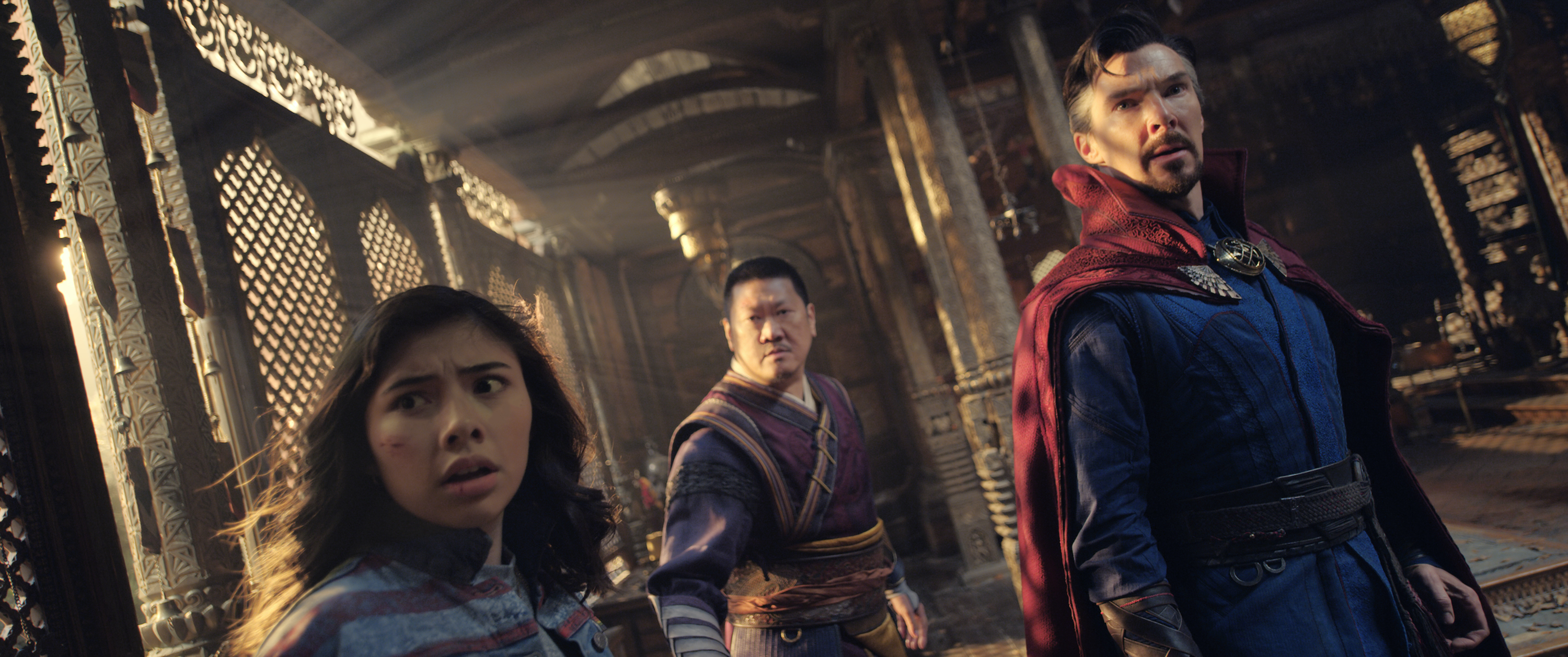 America Chavez, Wong, and Doctor Strange look anxiously toward the camera in Doctor Strange in the Multiverse of Madness