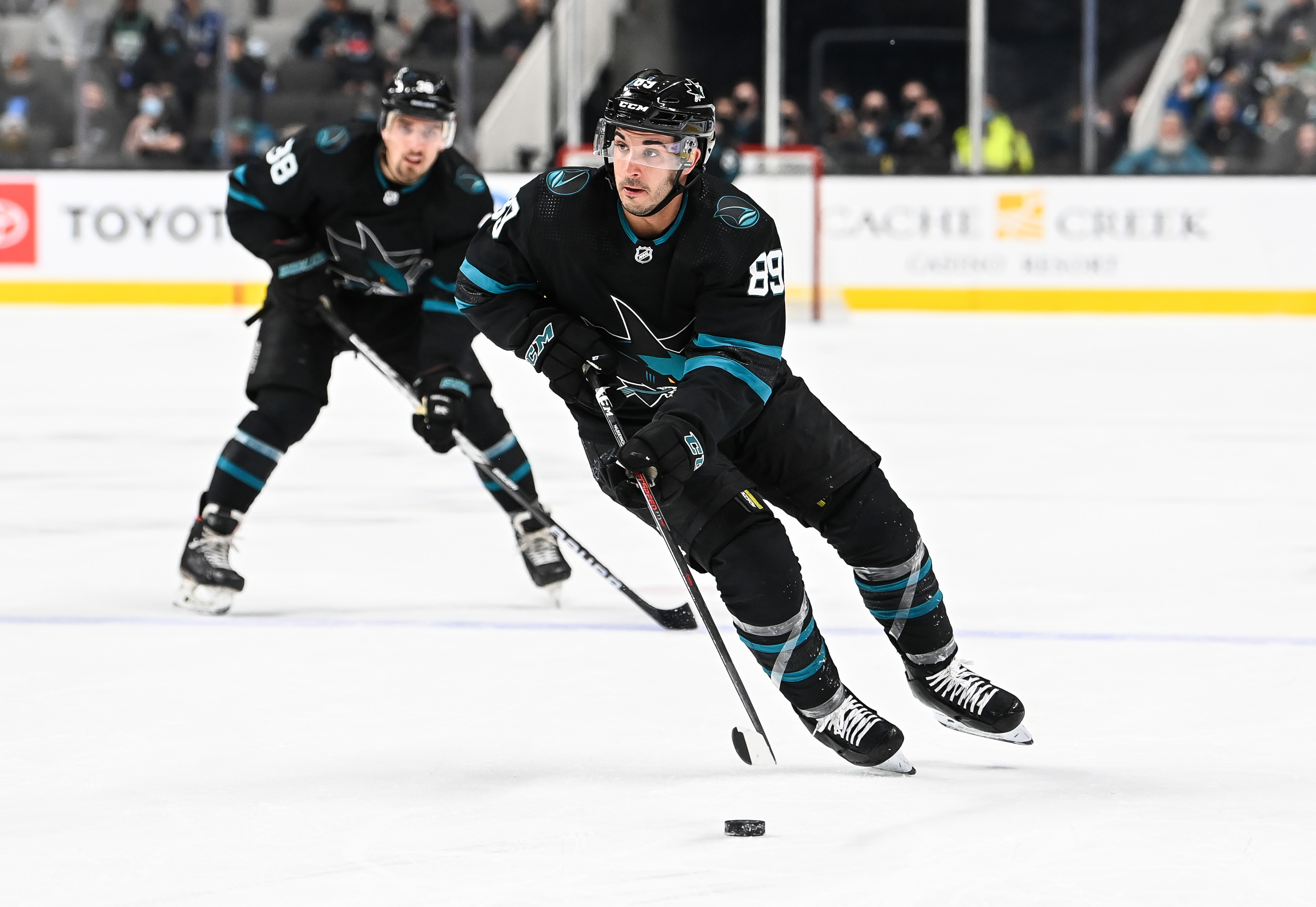 Jayden Halbgewachs #89 of the San Jose Sharks skates ahead with the puck against the Vancouver Canucks in a regular season game at SAP Center on December 16, 2021 in San Jose, California.