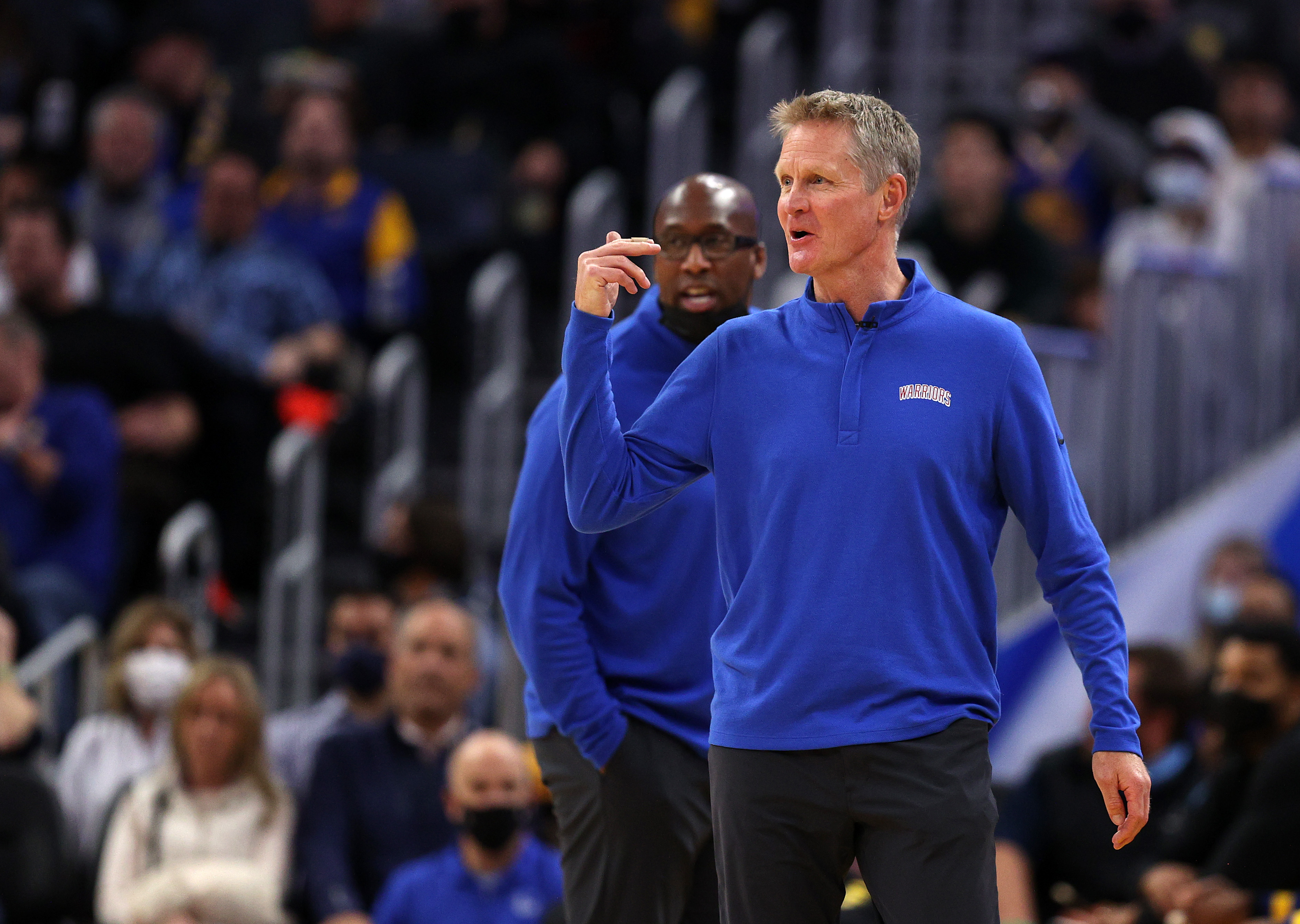 Steve Kerr roaming the sideline with Mike Brown in the background
