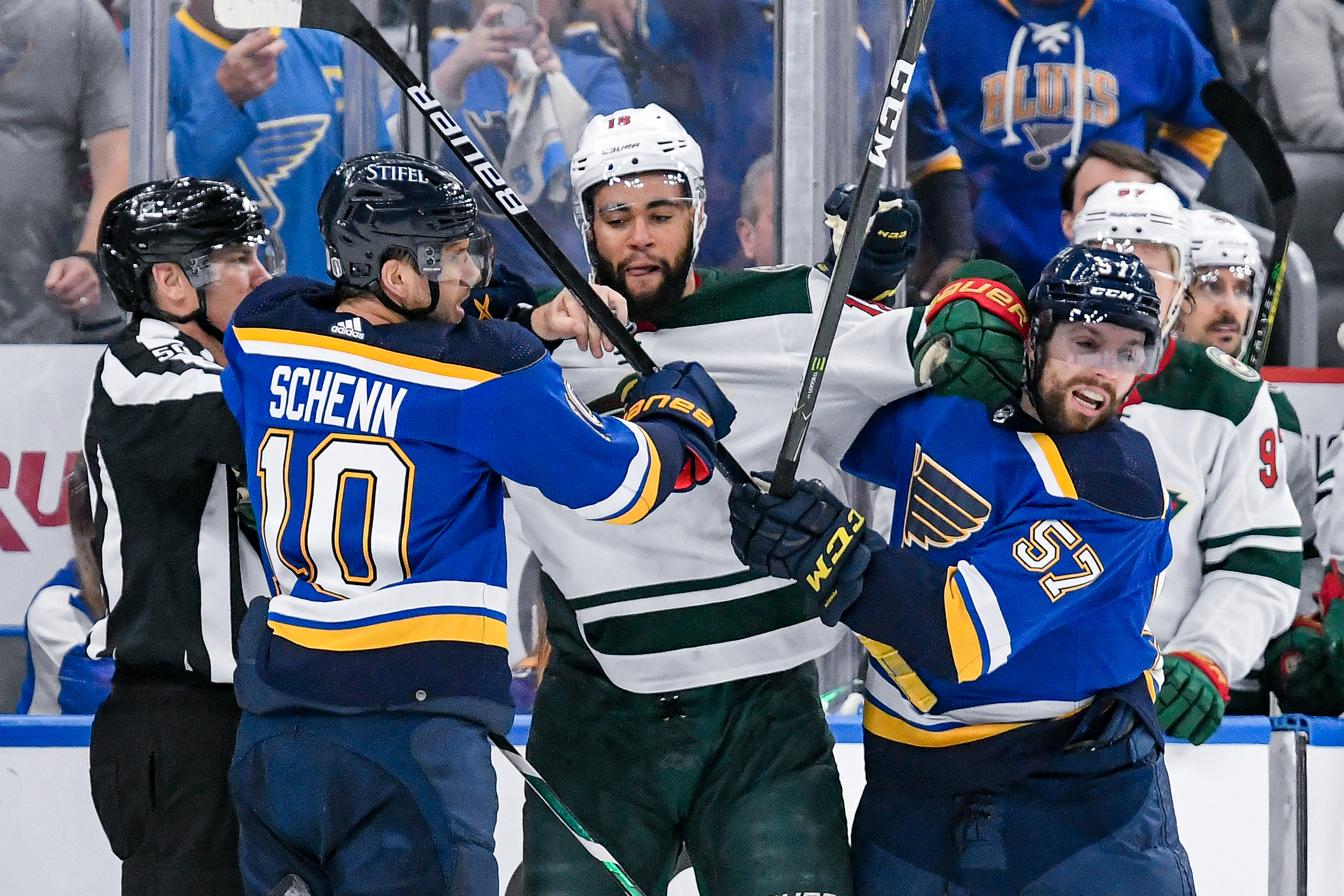 St. Louis Blues center Brayden Schenn (10) and St. Louis Blues left wing David Perron (57) push and shove with Minnesota Wild left wing Jordan Greenway (18) during Round 1 game 4 of the Stanley Cup Playoffs between the Minnesota Wild and the St. Louis Blues on April 29, 2022, at the Enterprise Center in St. Louis MO.