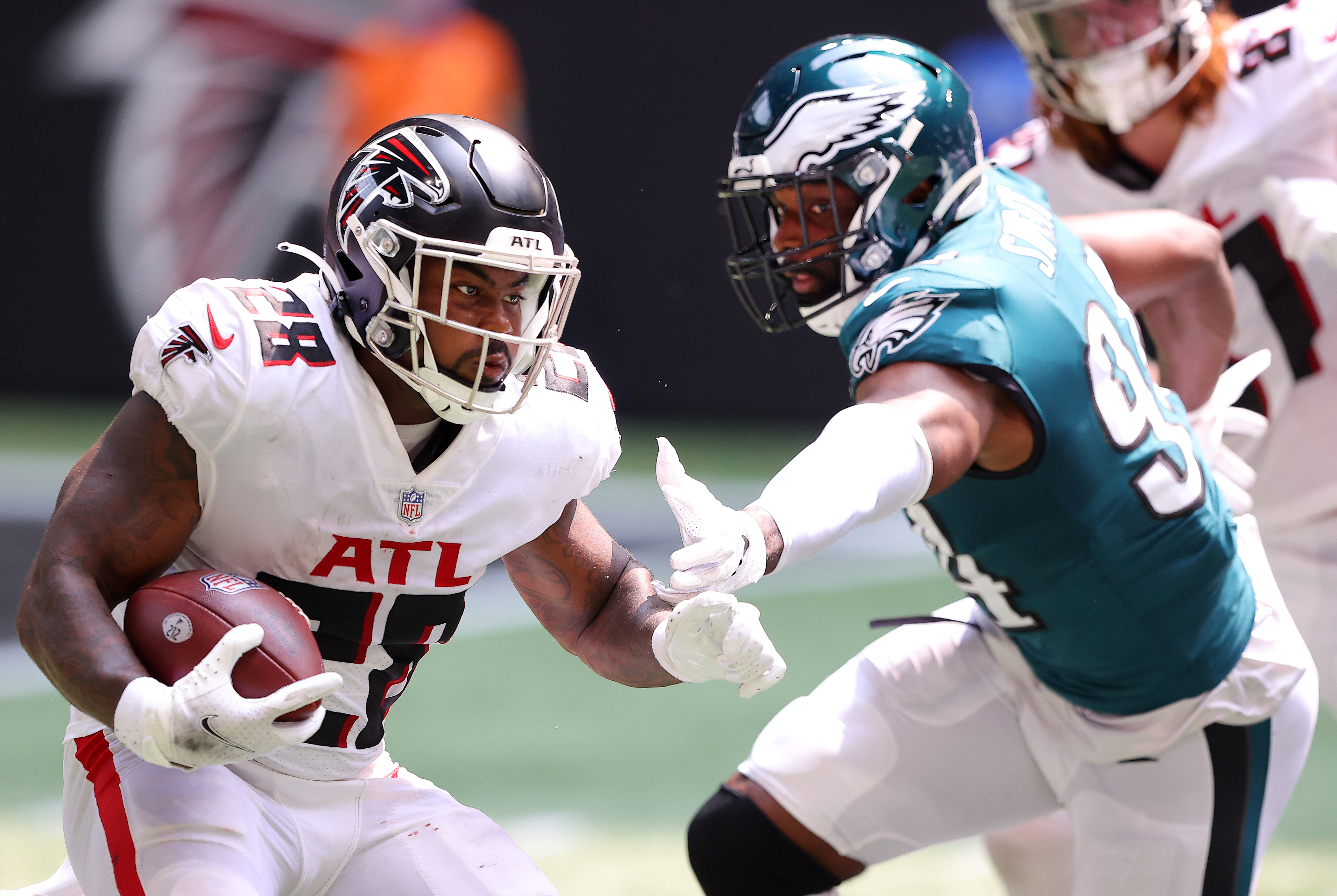 Mike Davis #28 of the Atlanta Falcons runs with the ball during the second quarter against the Philadelphia Eagles at Mercedes-Benz Stadium on September 12, 2021 in Atlanta, Georgia.