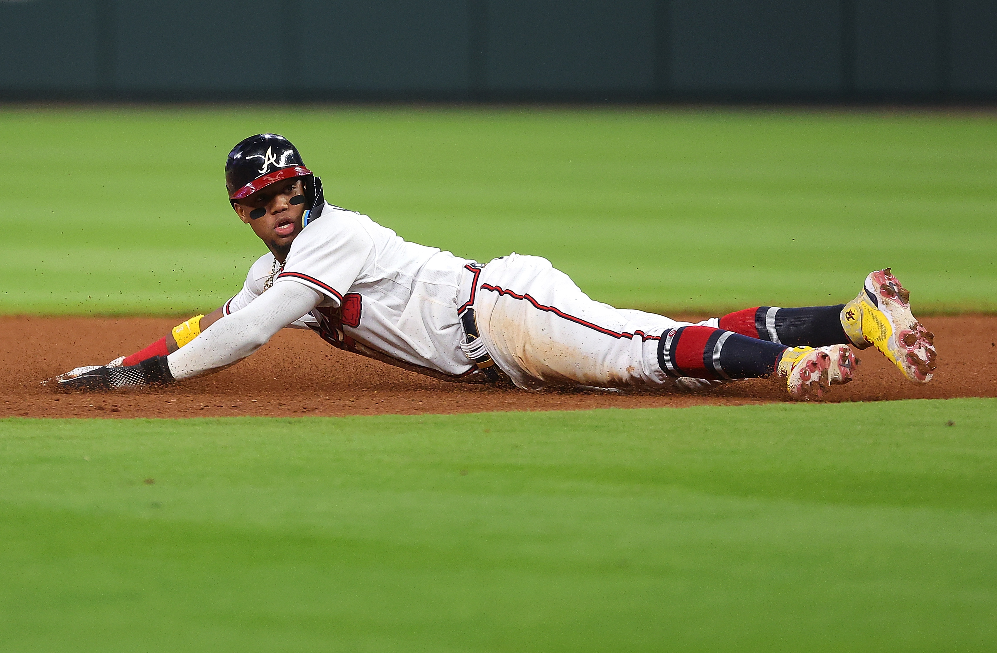 Ronald Acuna Jr. #13 of the Atlanta Braves looks back as he was attempting to steal second base against the Boston Red Sox prior to a single by Matt Olson #28 of the Atlanta Braves in the seventh inning at Truist Park on May 10, 2022 in Atlanta, Georgia.