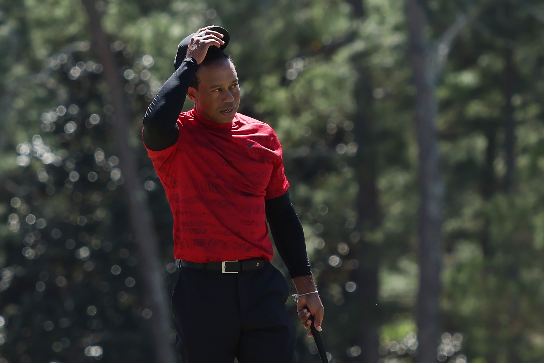 Tiger Woods tips his hat to the crowd on the 18th green after finishing his round during the final round of the Masters at Augusta National Golf Club on April 10, 2022 in Augusta, Georgia.