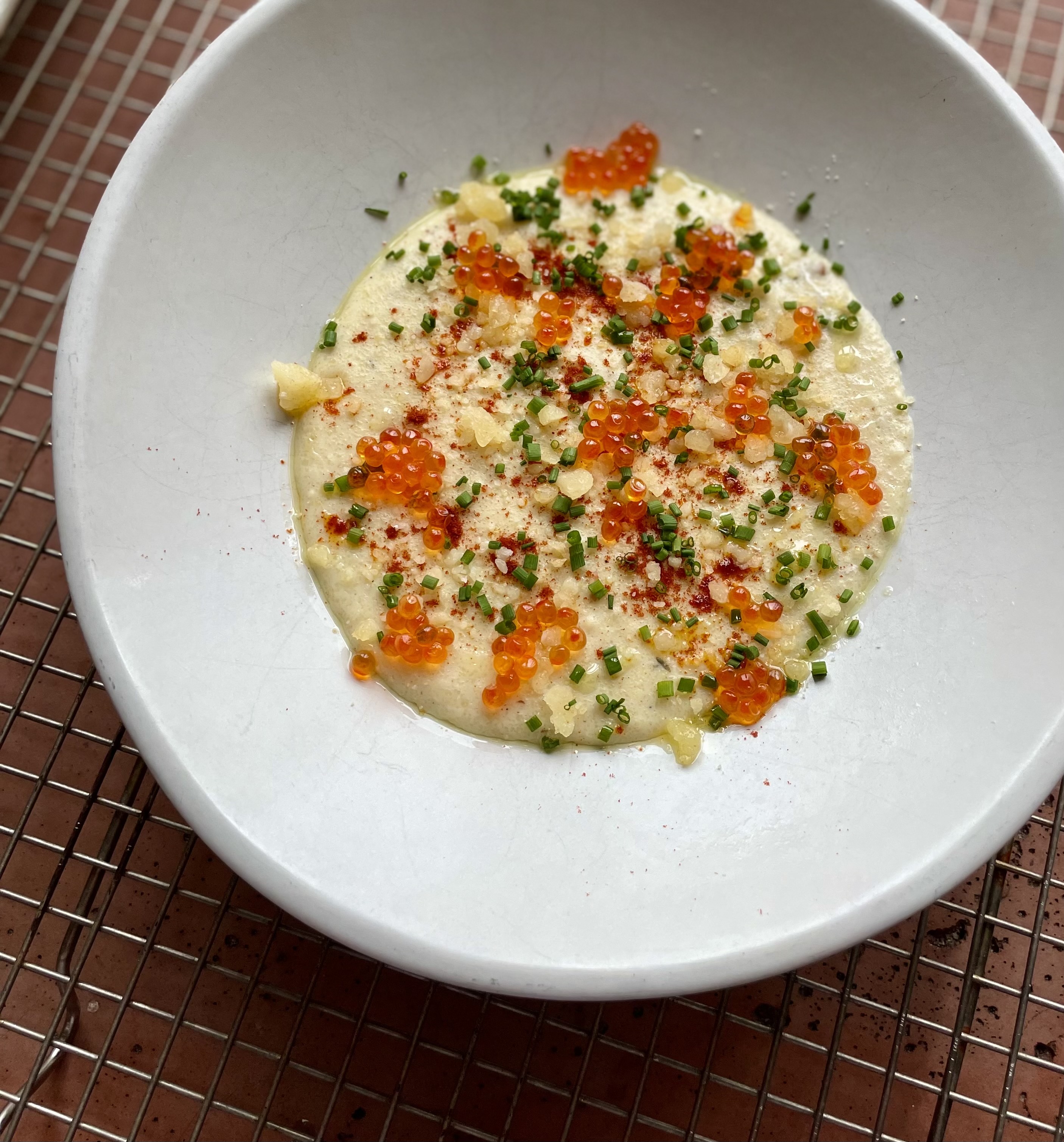plate of grits topped with caviar