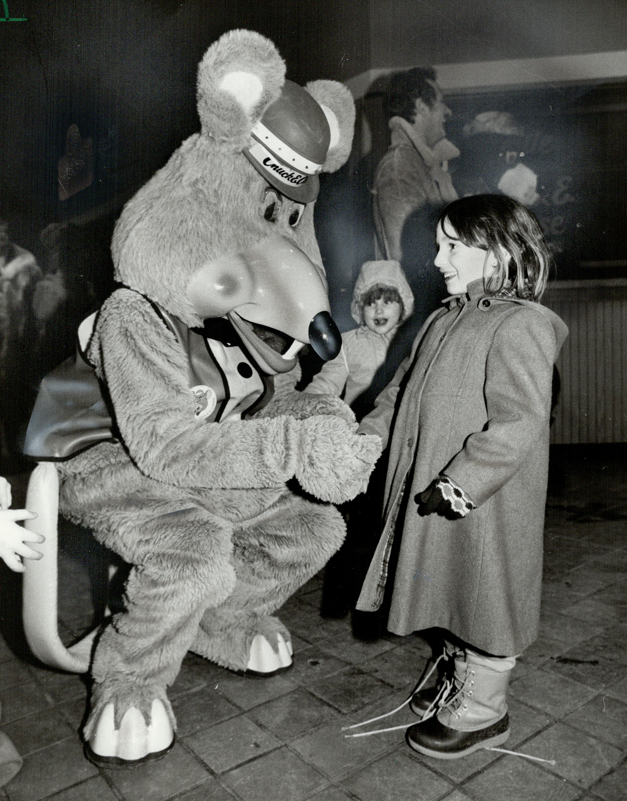 Say cheese: This little girl smells a rat. Actually a man in a rat’s suit. Adam Roberts; the man ins