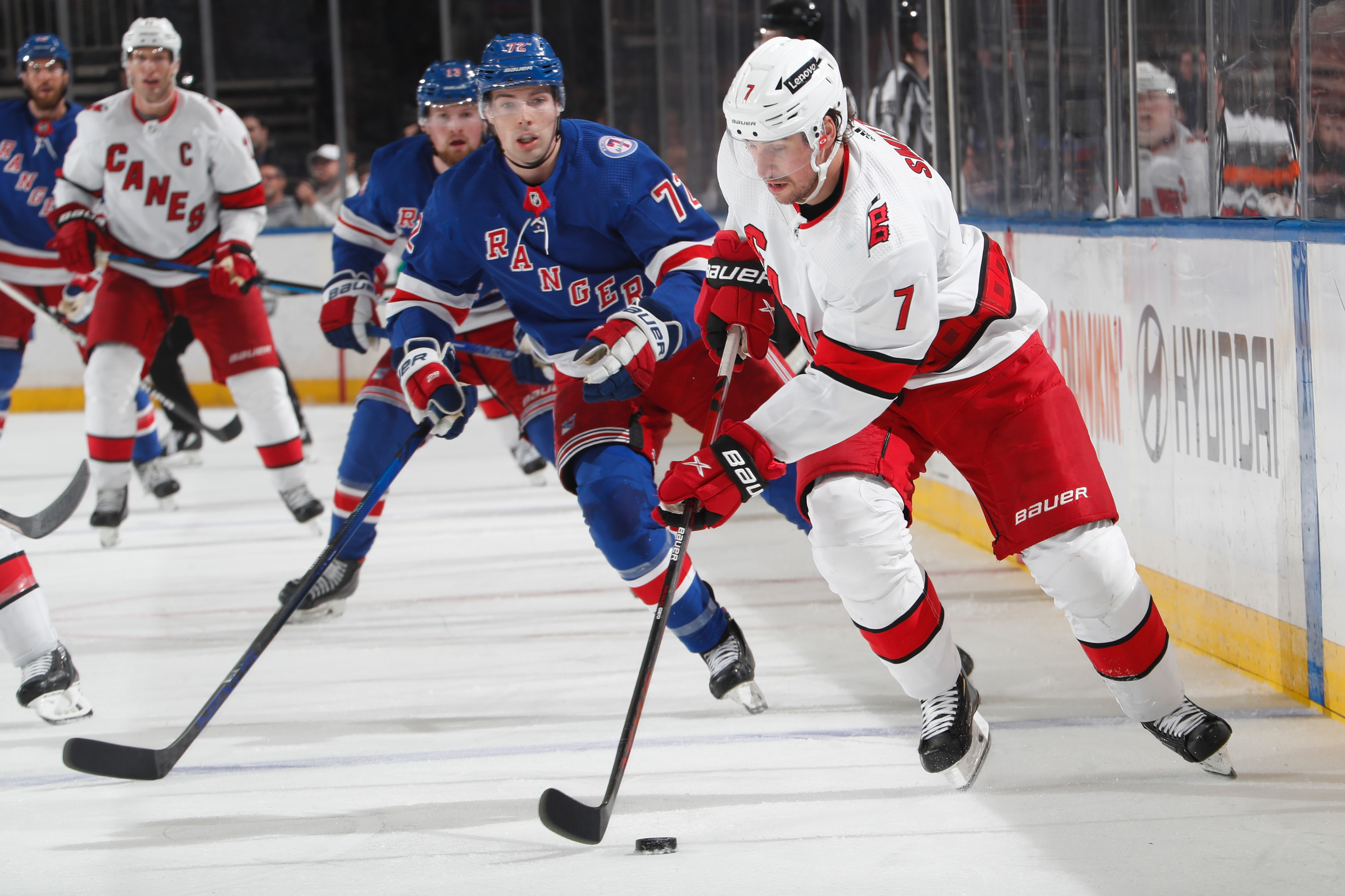Brendan Smith #7 of the Carolina Hurricanes skates with the puck against Filip Chytil #72 of the New York Rangers at Madison Square Garden on April 26, 2022 in New York City.
