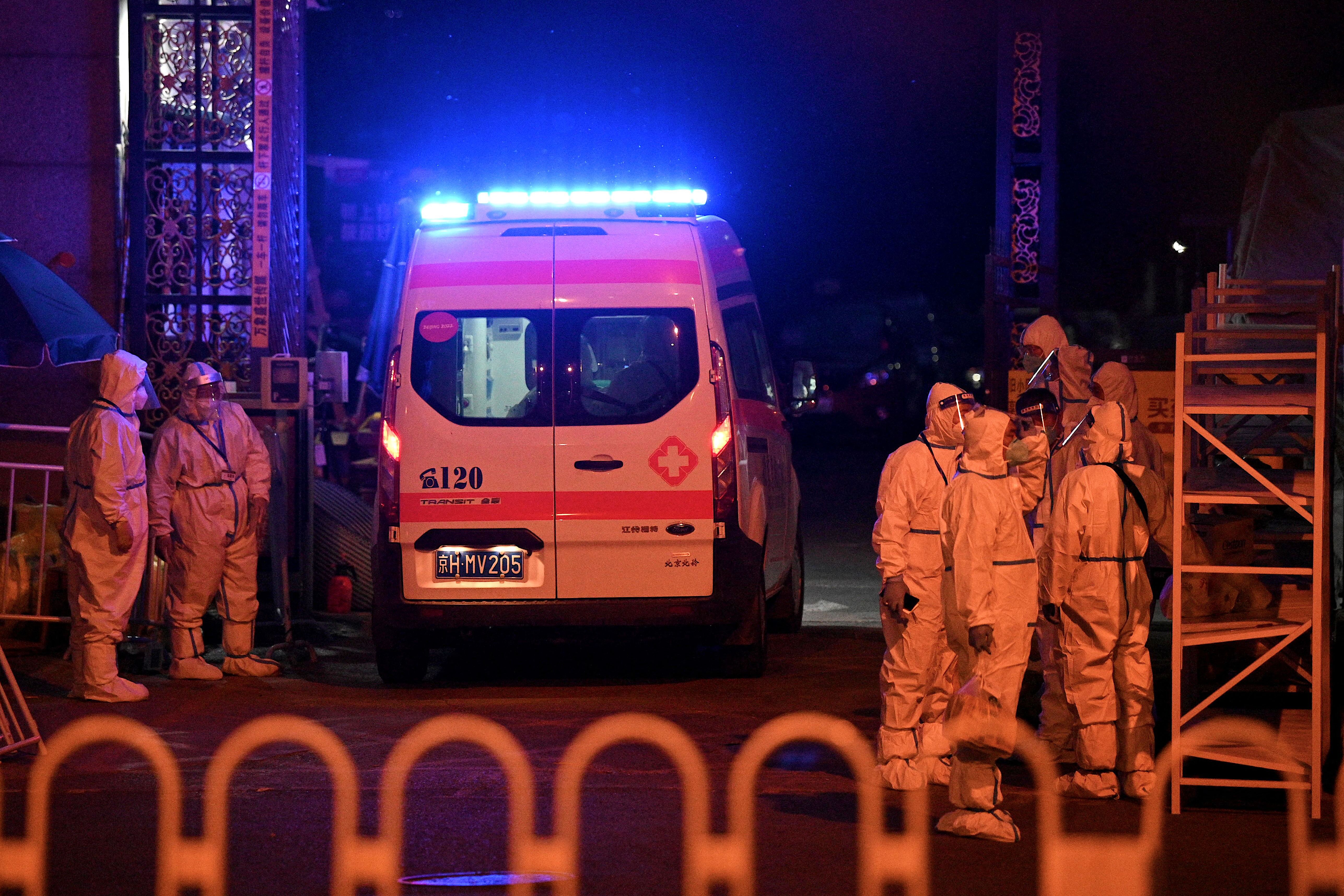 An ambulance enters a fenced residential area under lockdown due to Covid-19 restrictions in Beijing on May 17, 2022.