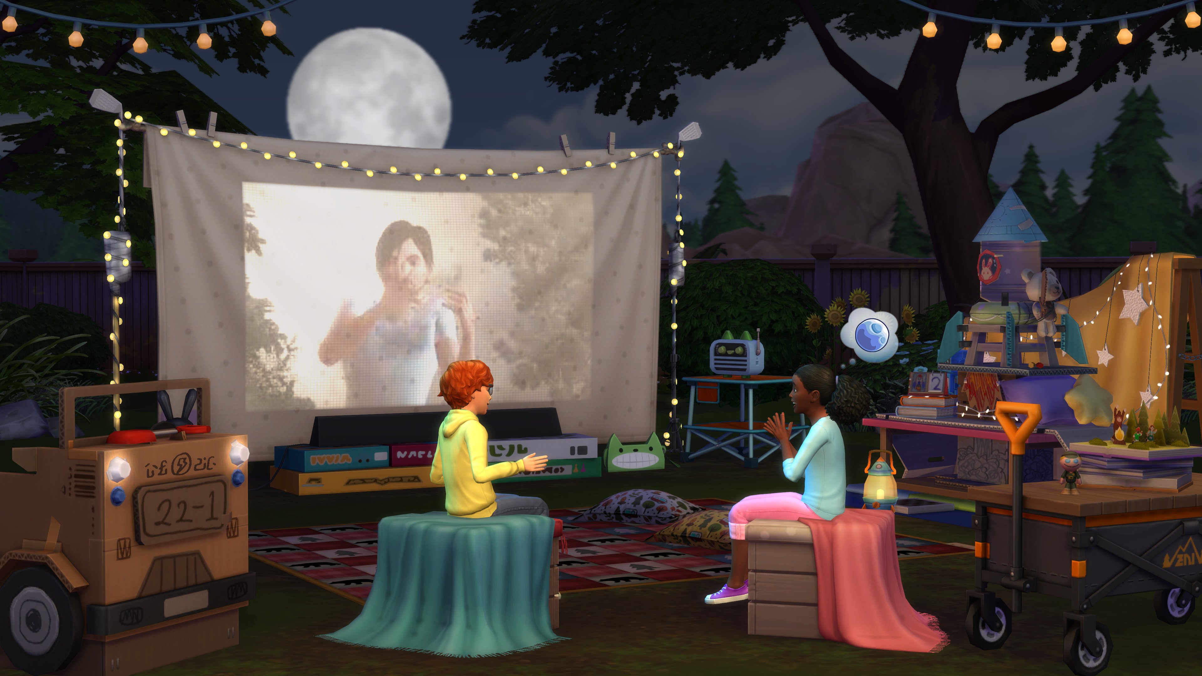 two sims characters sitting outside watching a movie projected onto a screen. there’s loads of items out in the yard. like a string lights, a rocket, and a laturn. 