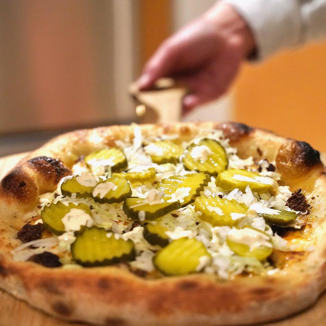 A pizza topped with pickles