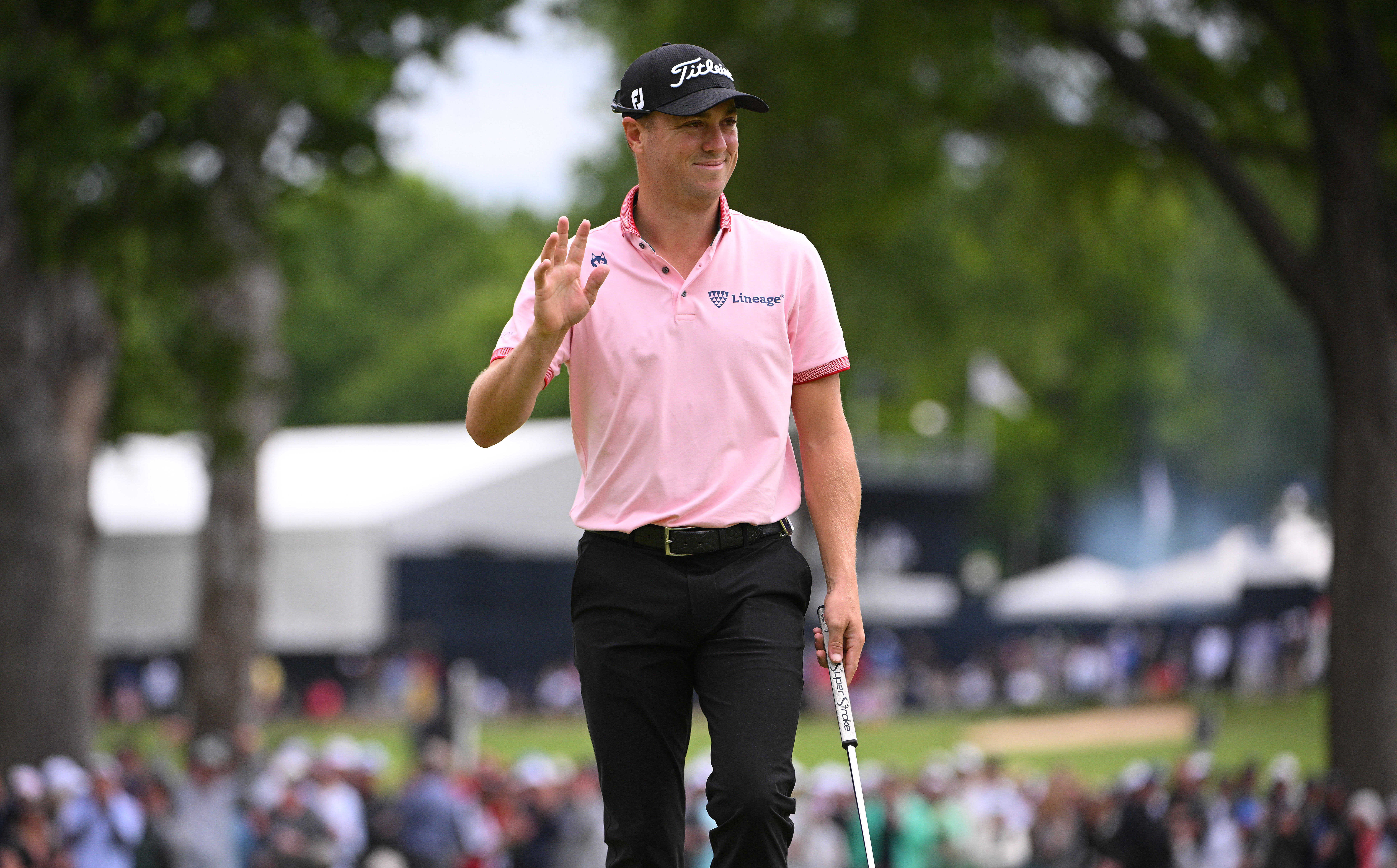 Justin Thomas acknowledges the crowd after making a putt on the sixth green during the final round of the PGA Championship golf tournament at Southern Hills Country Club.