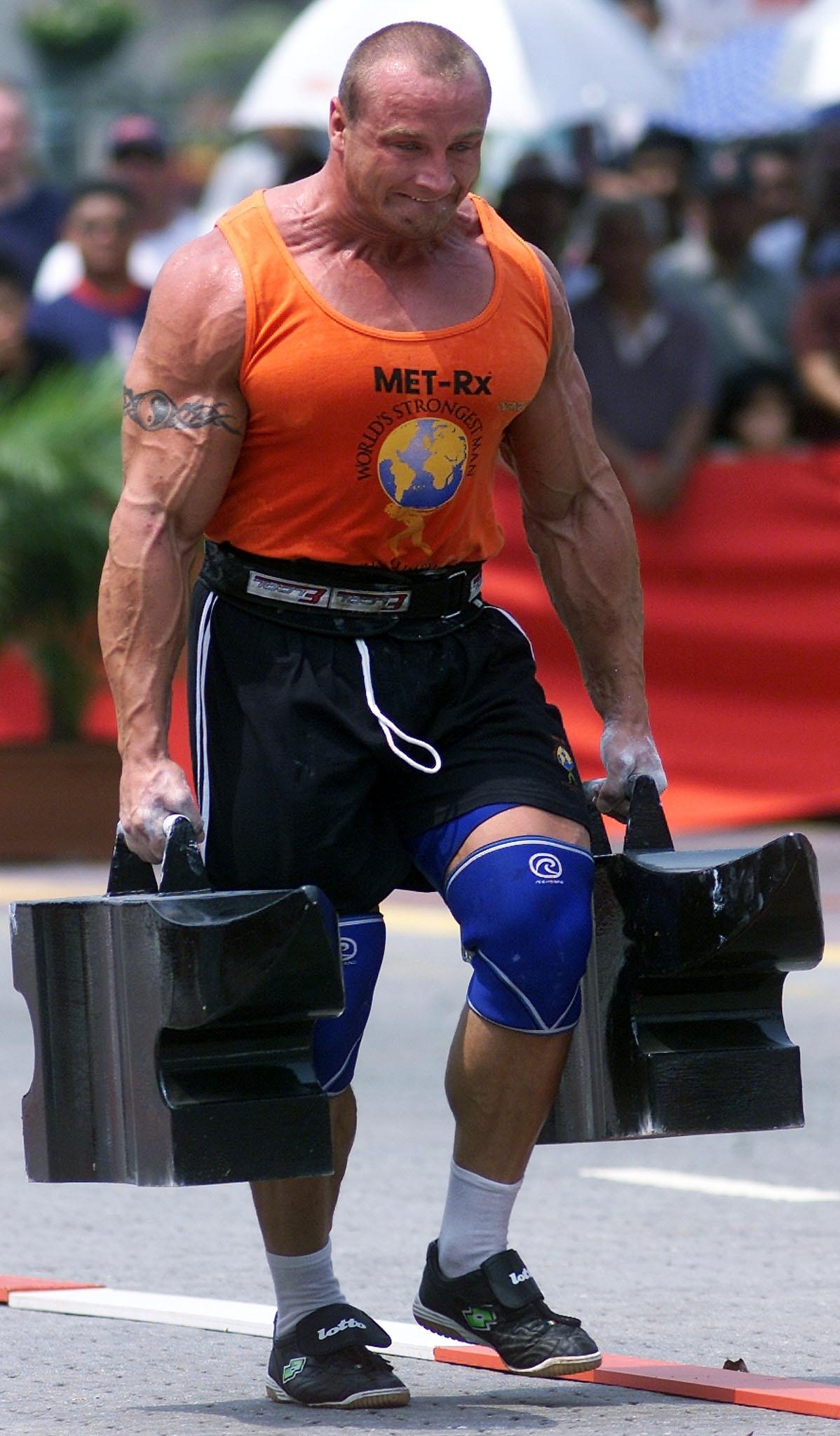 Mariusz Pudzianowski of Poland carries a total of
