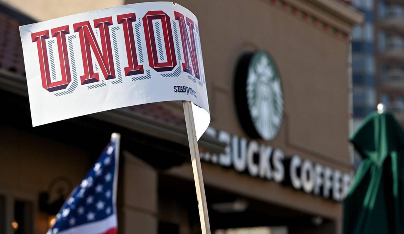 A sign reading “Union” waves outside a Starbucks store.