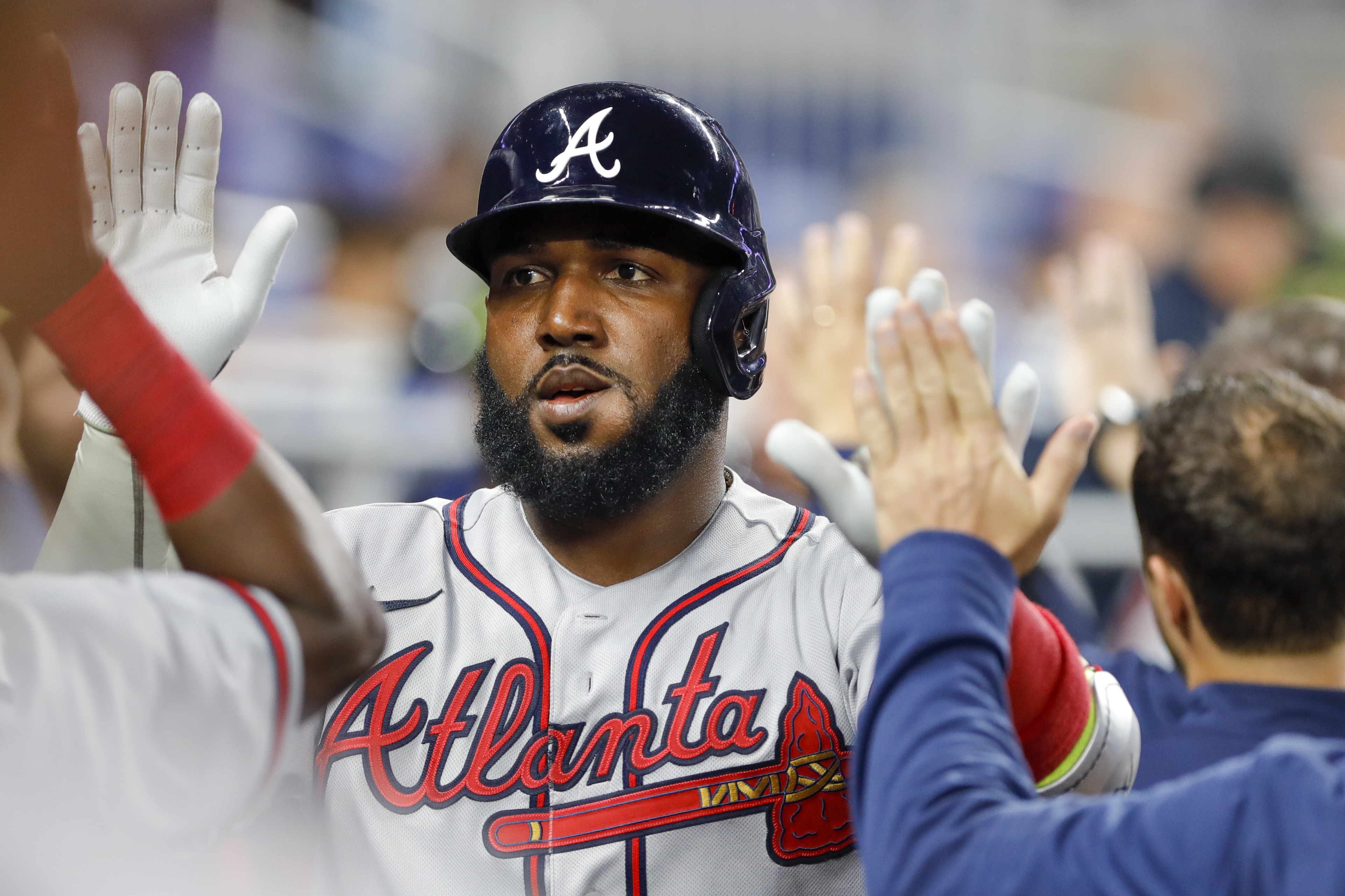 Atlanta Braves left fielder Marcell Ozuna (20) celebrates with teammates after hitting a home run during the first inning against the Miami Marlins at loanDepot Park.