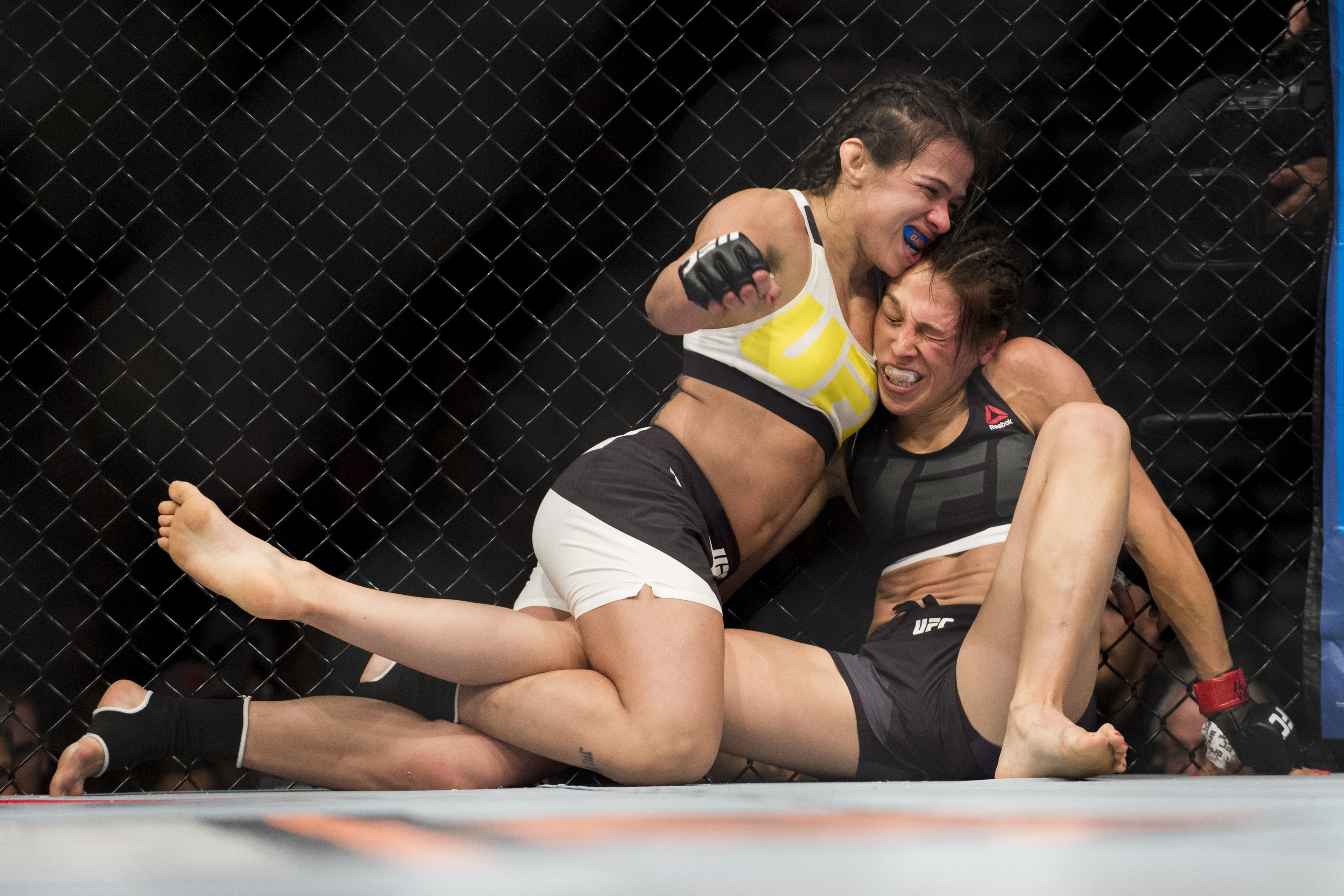 Claudia Gadelha and Joanna Jedrzejczyk engage in a grappling scramble in their 2016 title fight. 