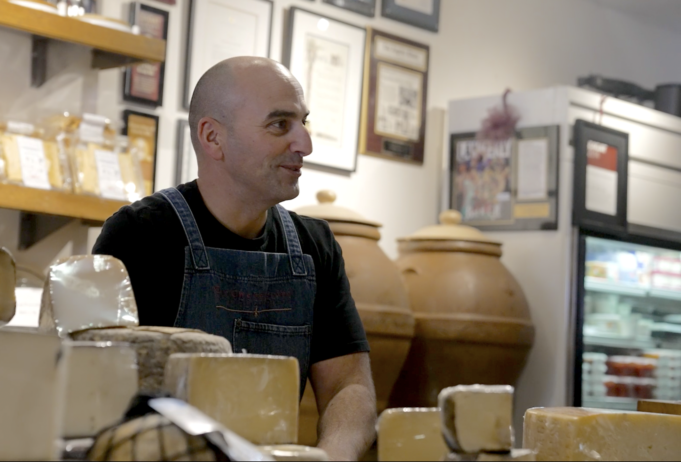 Dominick DiBarolomeo, the new owner of the Beverly Hills Cheese Store standing behind the counter.