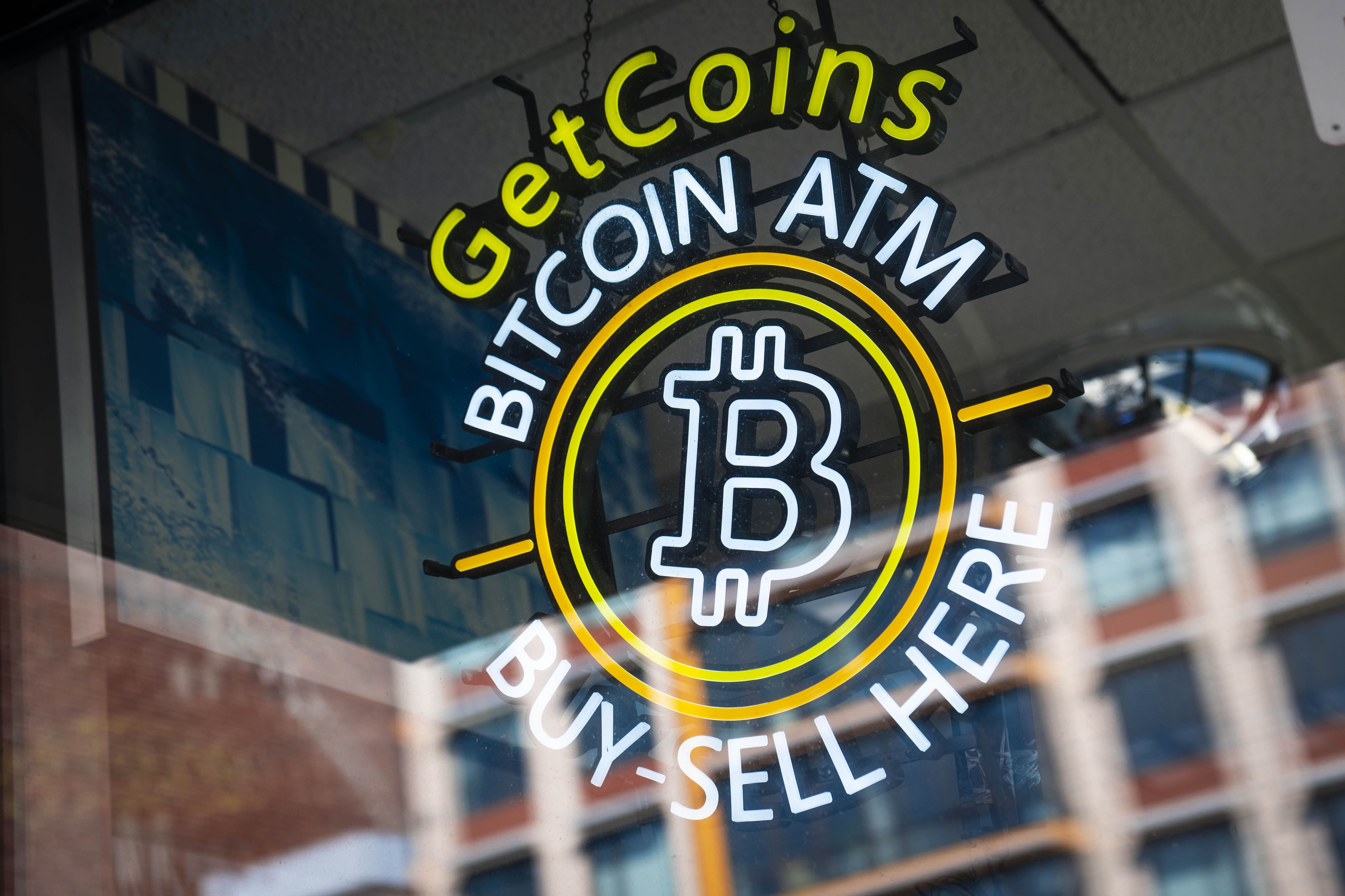 A sign for a bitcoin ATM in Washington, DC, reads “Get coins, bitcoin ATM, buy sell here.”