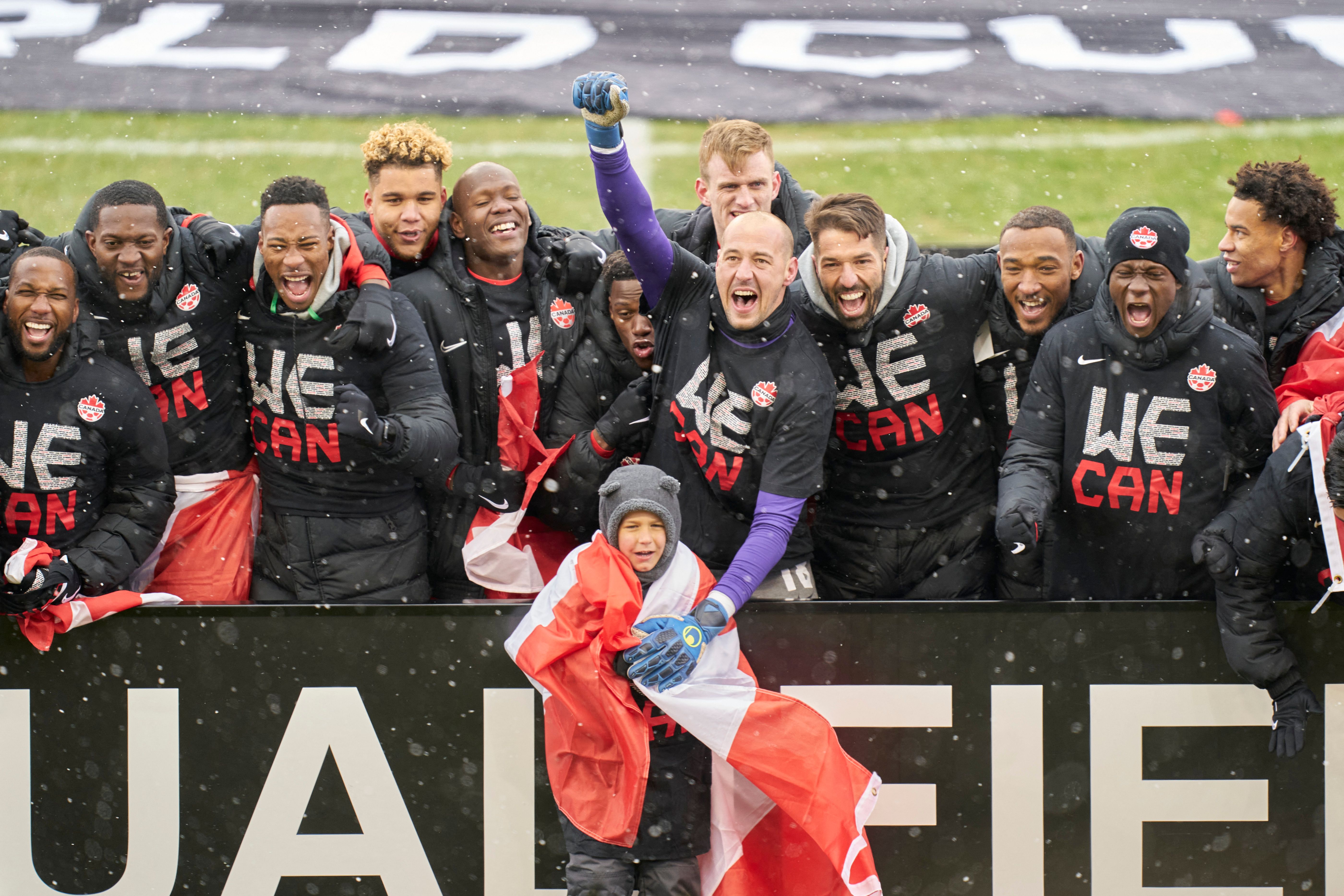 The Canadian mens national team celebrate after defeating Jamaica 4-0 in their World Cup Qualifying match at BMO Field in Toronto, Ontario, Canada on March 27, 2022. - Canada qualified for the World Cup for the first time in 36 years on Sunday with an emphatic 4-0 victory over Jamaica in Toronto.