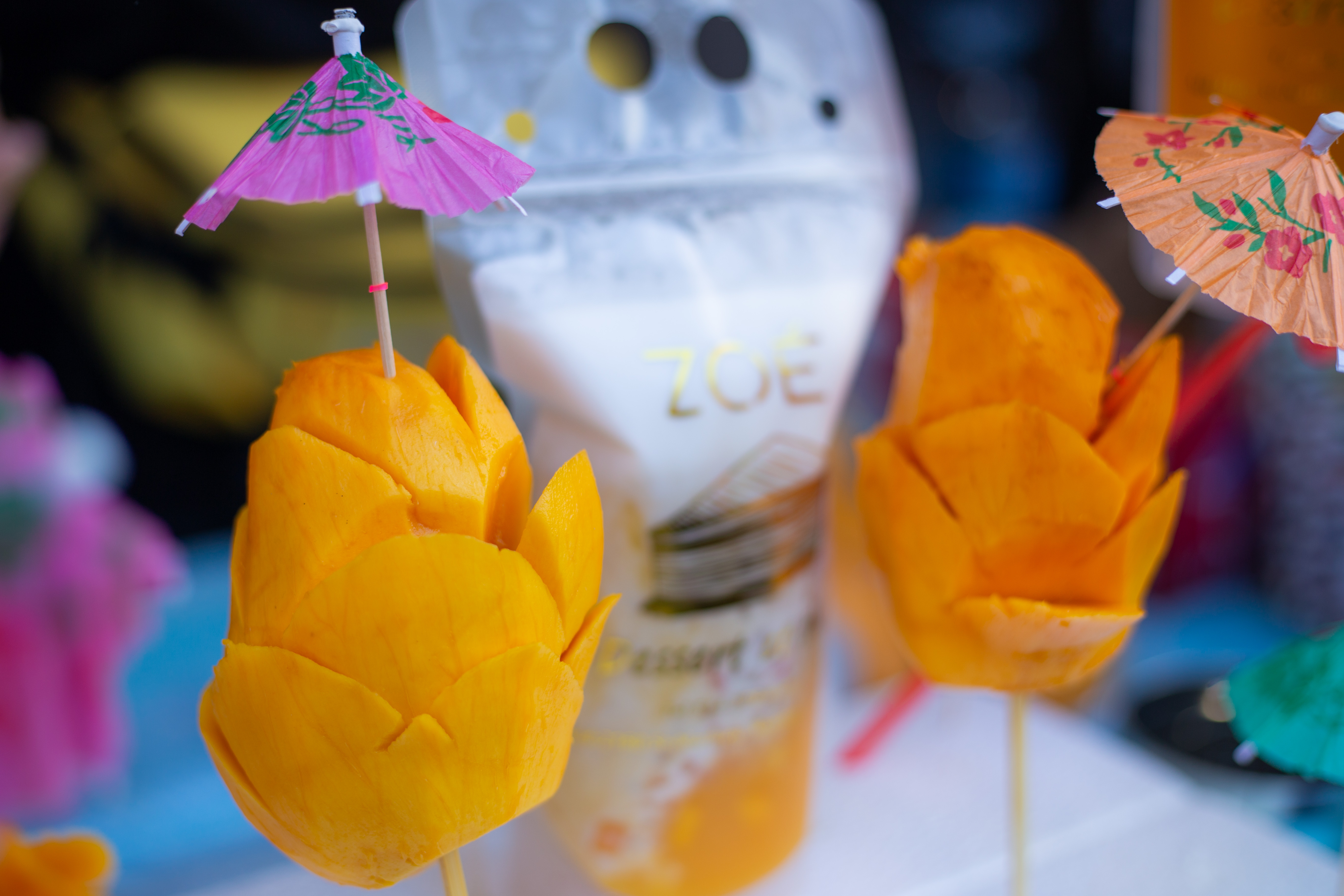 two mango sticks with umbrellas