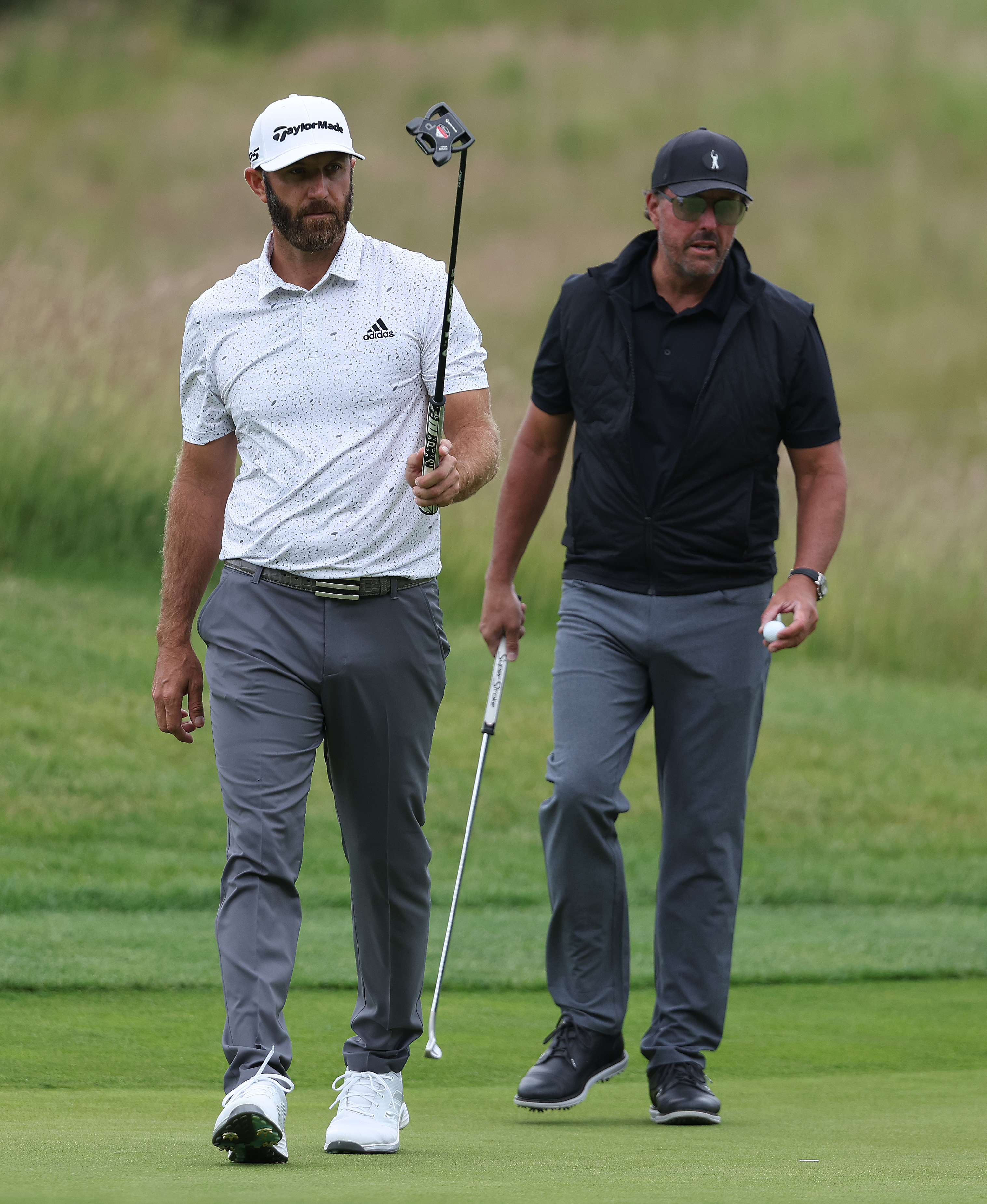 Dustin Johnson and Phil Mickelson of the United States pictured on the 4th green during day one of the LIV Golf Invitational at The Centurion Club on June 09, 2022 in St Albans, England.